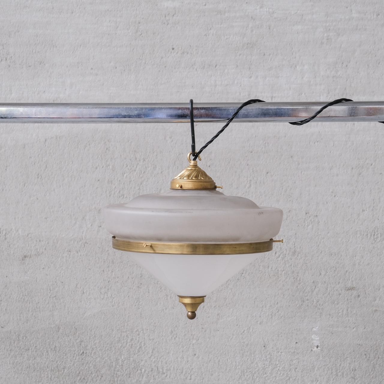 Two tone glass pendants, with brass rim, gallery and finial.

France, c1960s.

Opaque glass top, opaline glass base.

PRICED AND SOLD INDIVIDUALLY.

5 available at the time of listing.

No chain or rose was retained, however they are easy to source