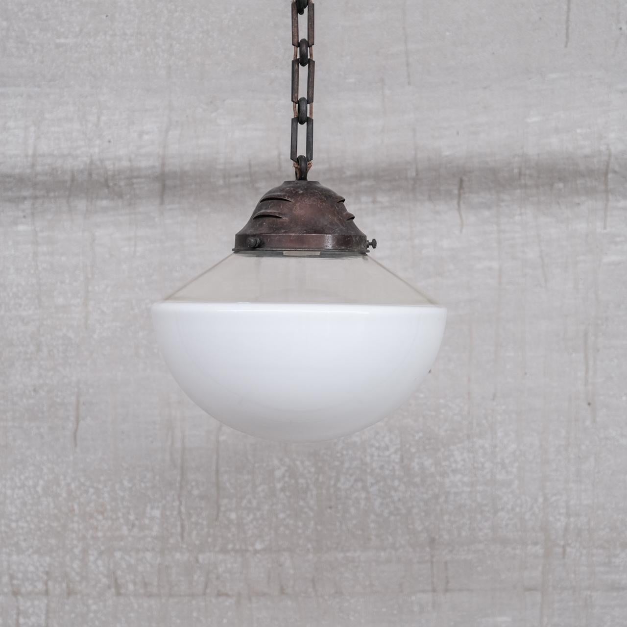 A good quality two tone pendant light. 

France, c1950s. 

Opaline glass base, clear top, all one glass shade. 

Naturally patinated metal gallery, likely brass. 

Some original chain provided, no ceiling rose was retained. 

Since