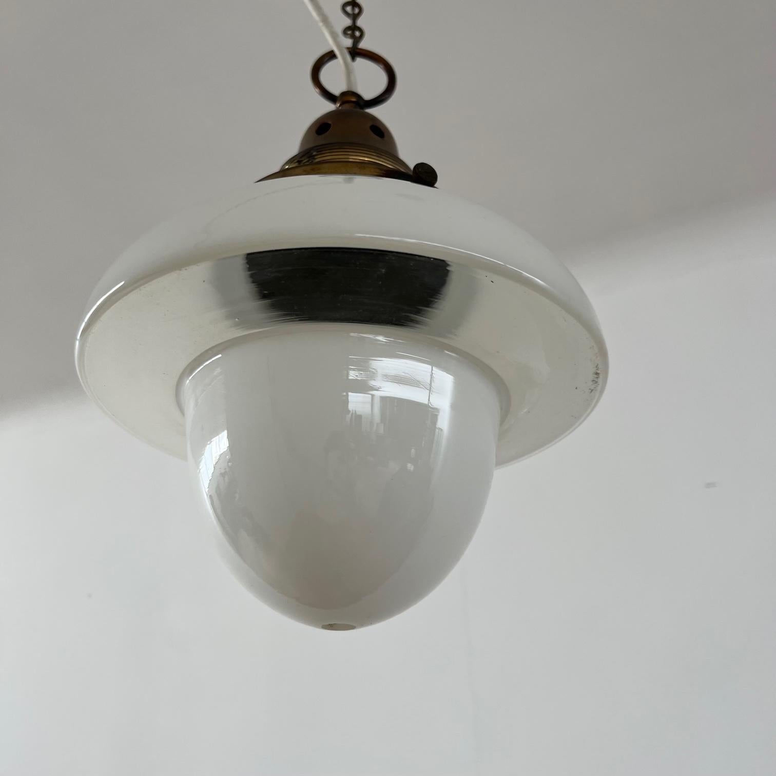 Brass and opaline glass pendant lights. 

England, c1950s. 

Clear underside to the rim, the rest remains opaline white. 

Acorn style shape, good quality brass gallery. 

PRICED AND SOLD INDIVIDUALLY. 

Since re-wired and PAT tested. 

Location: