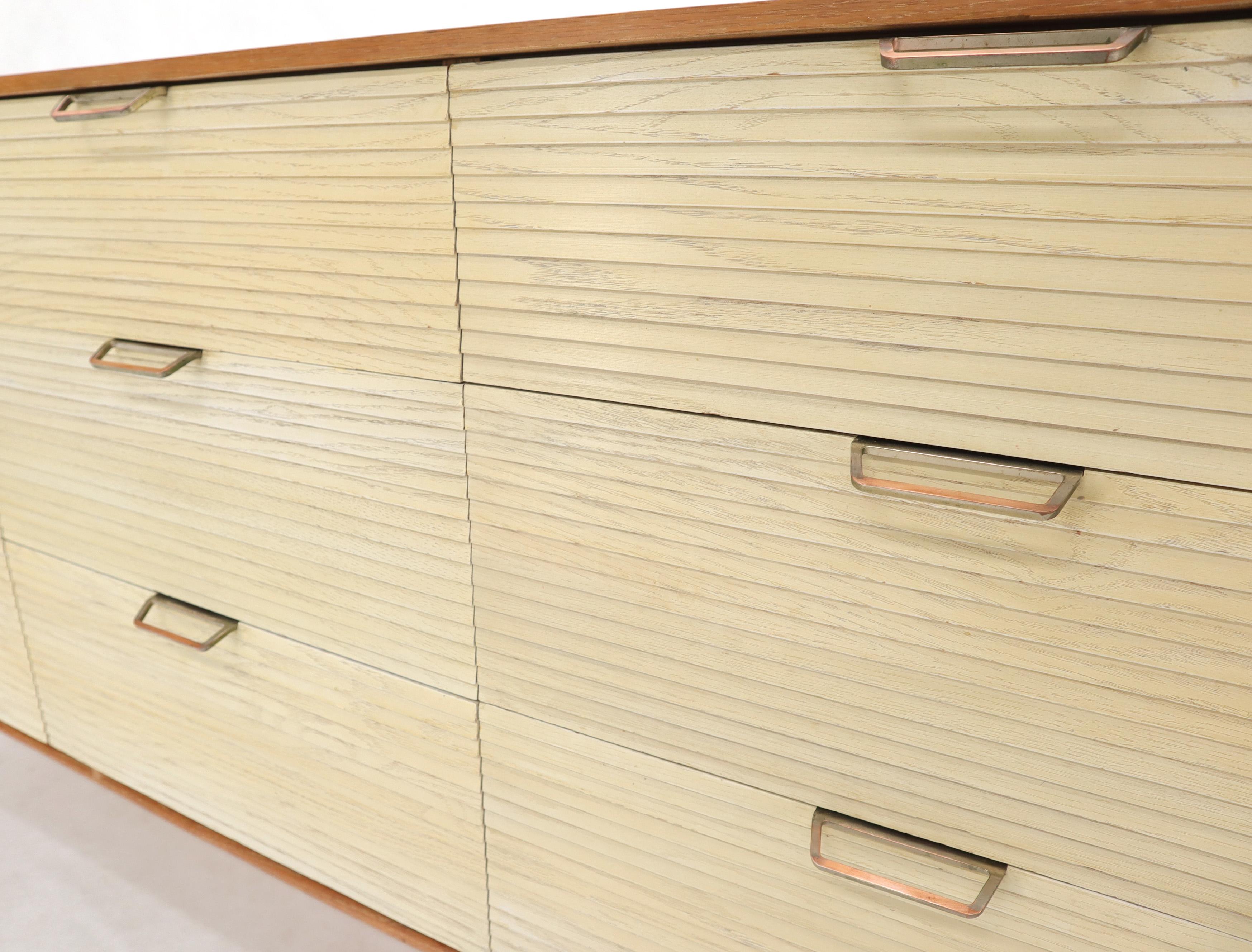 Mid-Century Modern perused oak dresser by Mengel. Two-tone finish natural oak with white louver shape drawer fronts. Dowel shape legs with stretchers. NYC area delivery starts from $150.
