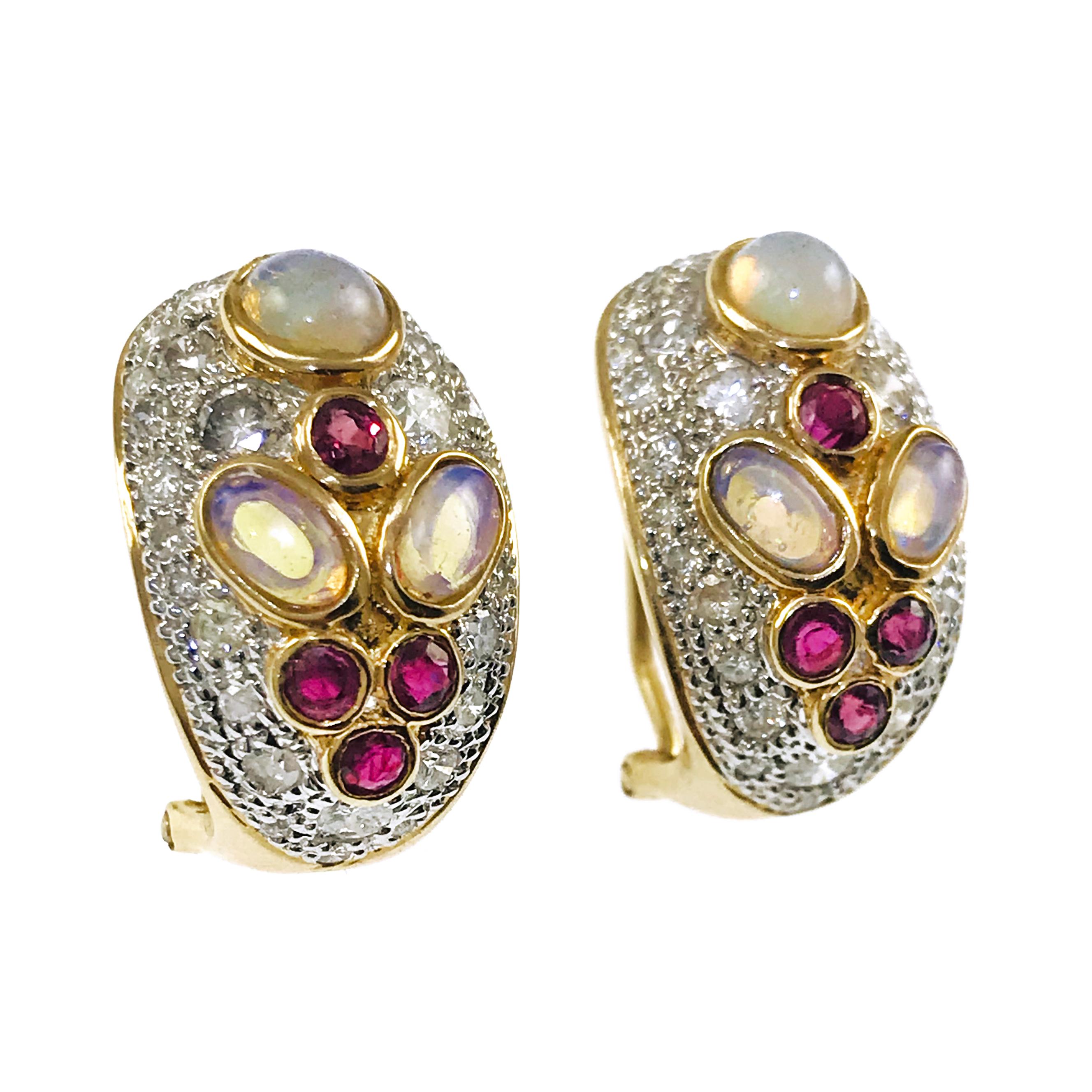 14 Karat Two-Tone White and Yellow Gold Opal Ruby Diamond Clip-On Earrings. Three bezel-set Opals, one round, two oval, four round bezel-set Ruby's set in yellow gold and 60 pavé-set diamonds on each earring set in white gold. The round Opal
