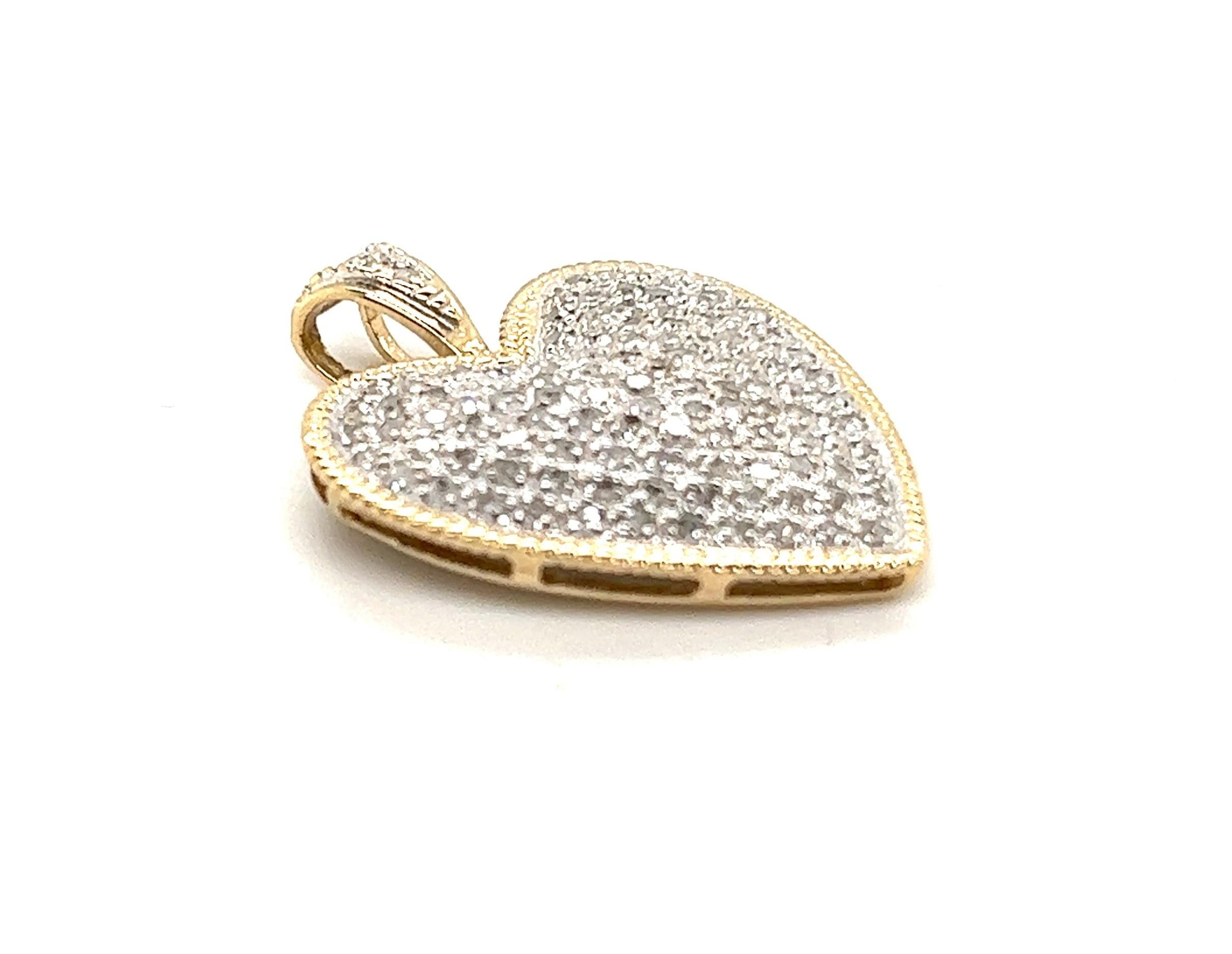 14KT yellow and white gold (Stamped) approximately 1.55 carat H-I color and I1-I2 clarity diamond pave set heart pendant. 

The pendant measures 1  3/16 high to 1 inch at the widest point. 
