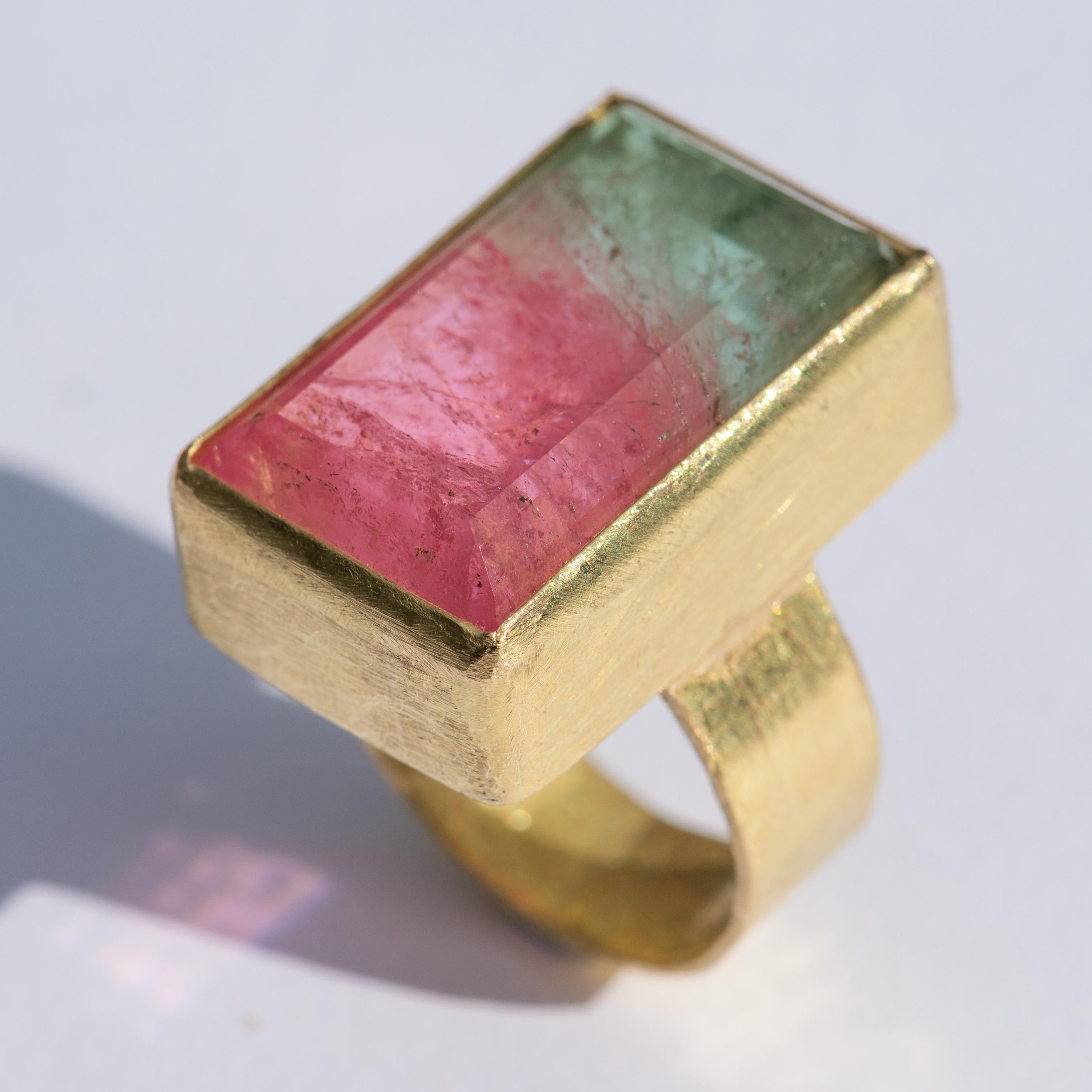 A two tone pink and mint green tourmaline, 31.48 carats rectangular stone set in hammered textured 18kt gold. 

Often known as a Watermelon Tourmaline this is a beautiful example of Tourmaline as it transitions from one colour to another. The fresh