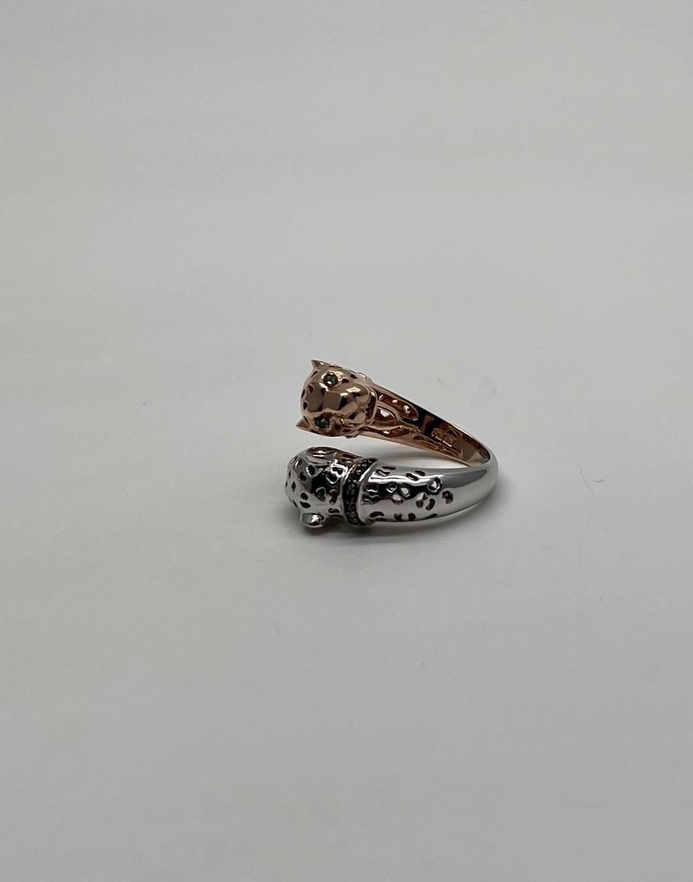 A striking ring, this exquisite piece features a unique design with two panther heads. One head is in a polished rose gold tone, while the other is in a sleek white gold finish. The intricate detailing on the heads includes cut-out spots and small,