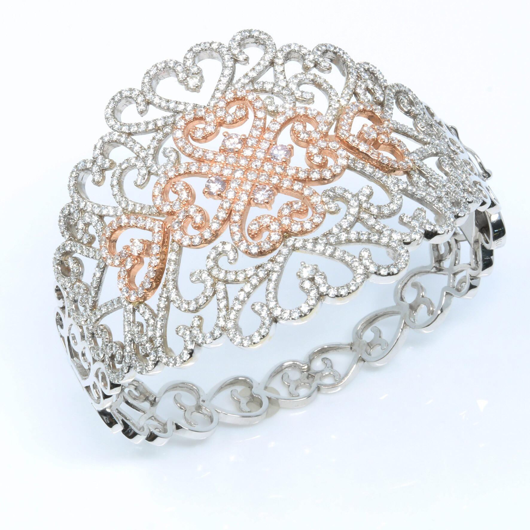 This intricately detailed bangle is crafted in a 14-karat rose gold center surrounded by white gold.   The filigree design is embellished with diamonds. Give yourself a  glamorous and prestigious look with this exquisite bangle.


Diamond