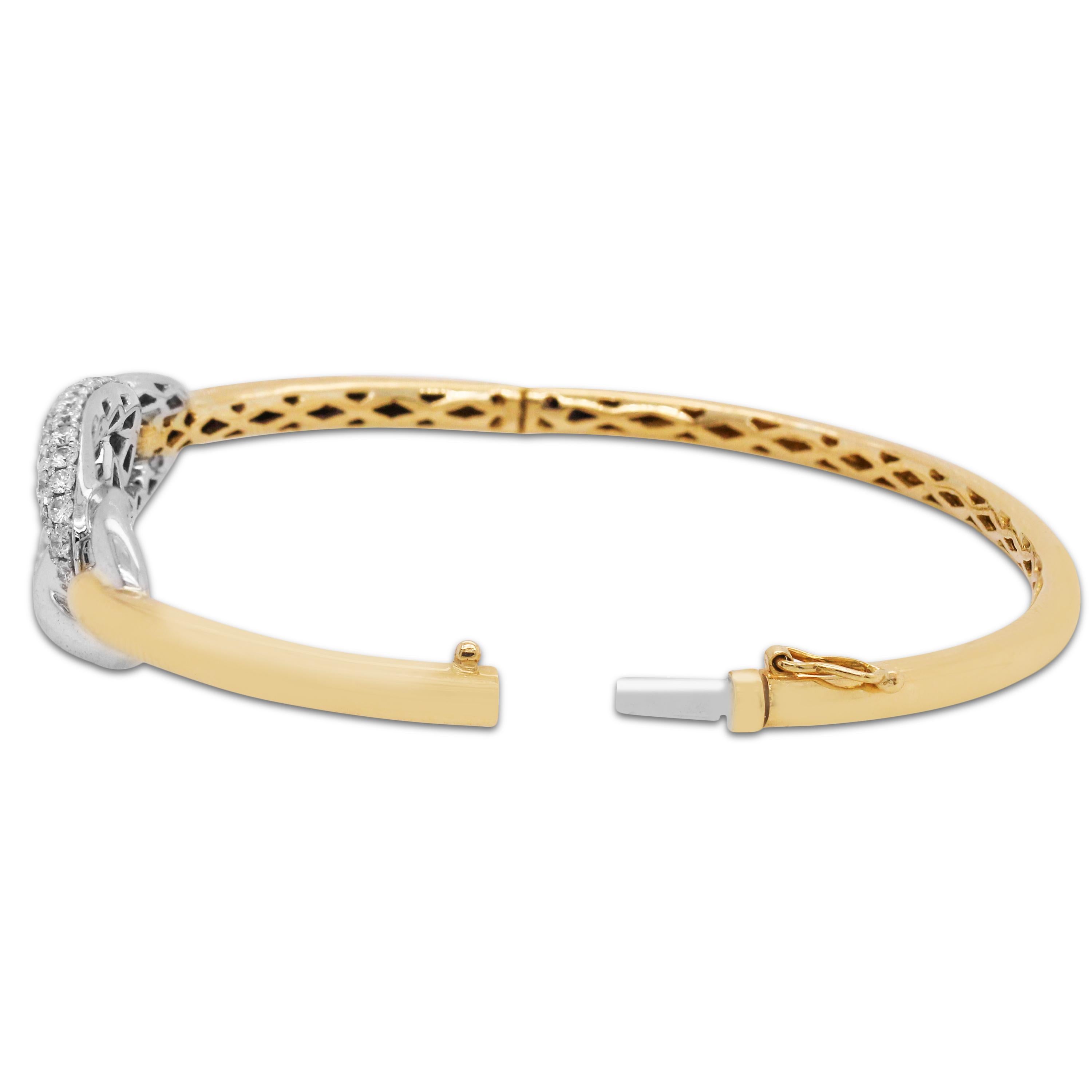 18K Two-Tone Yellow and White Gold and Diamond Bangle Bracelet

2.25 carat diamonds

Diamond center is 0.55 inch width. Bracelet is a size 7.