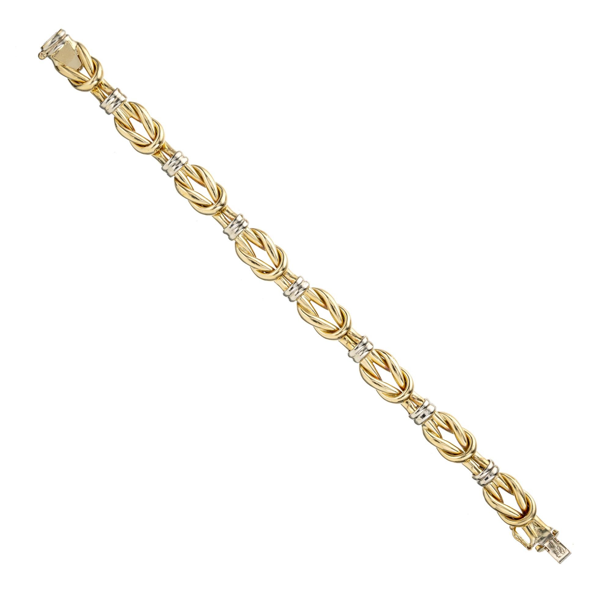 This Two Tone Yellow White Gold Italian Knot Bracelet that effortlessly combines elegance and contemporary style. This bracelet features a unique design of intertwining 18k yellow and white gold knots. Measures at 7.25 inches. Secure clasp with a