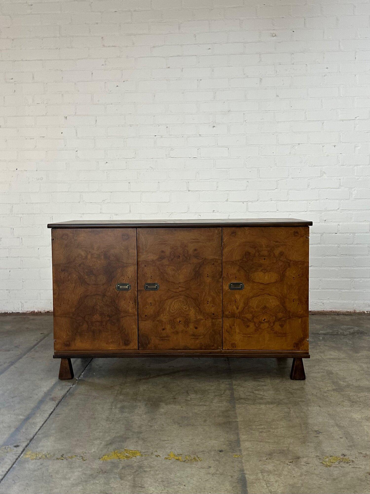 W56 D19 H33

Burlwood and Walnut stained Oak credenza. Fully refinished and structurally sound. Item features trapezoid legs and brass hardware.

Circa 1970’s