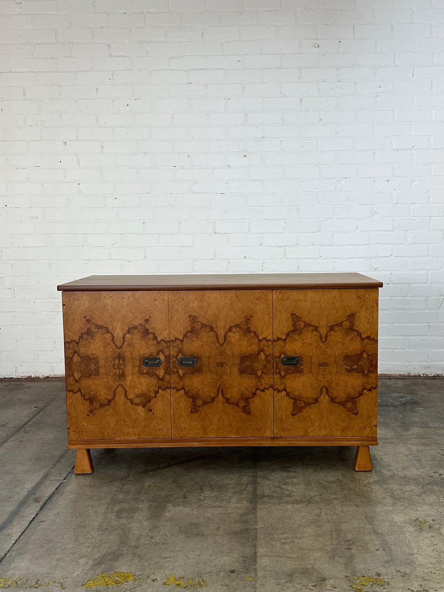 W56 D19 H33

Burlwood and oak credenza fully refinished and structurally sound. Item features trapezoid legs and brass hardware.

Circa 1970’s