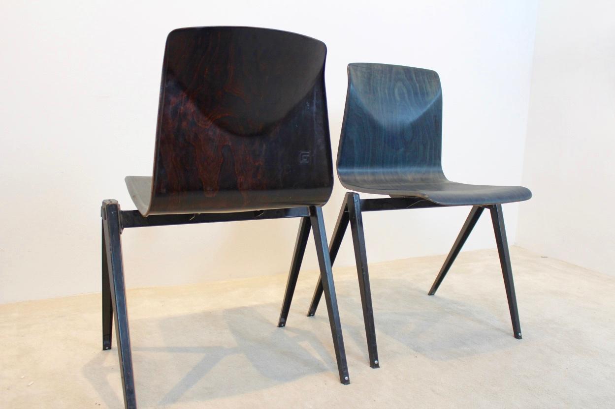 Highly wanted industrial stacking chairs by Pagholz. Galvanitas, never seen in this Two-toned coloring with black frame. The backside of the shells are in darkbrown or wenge and the front side is in amazing green-blue with beautiful flamed motive