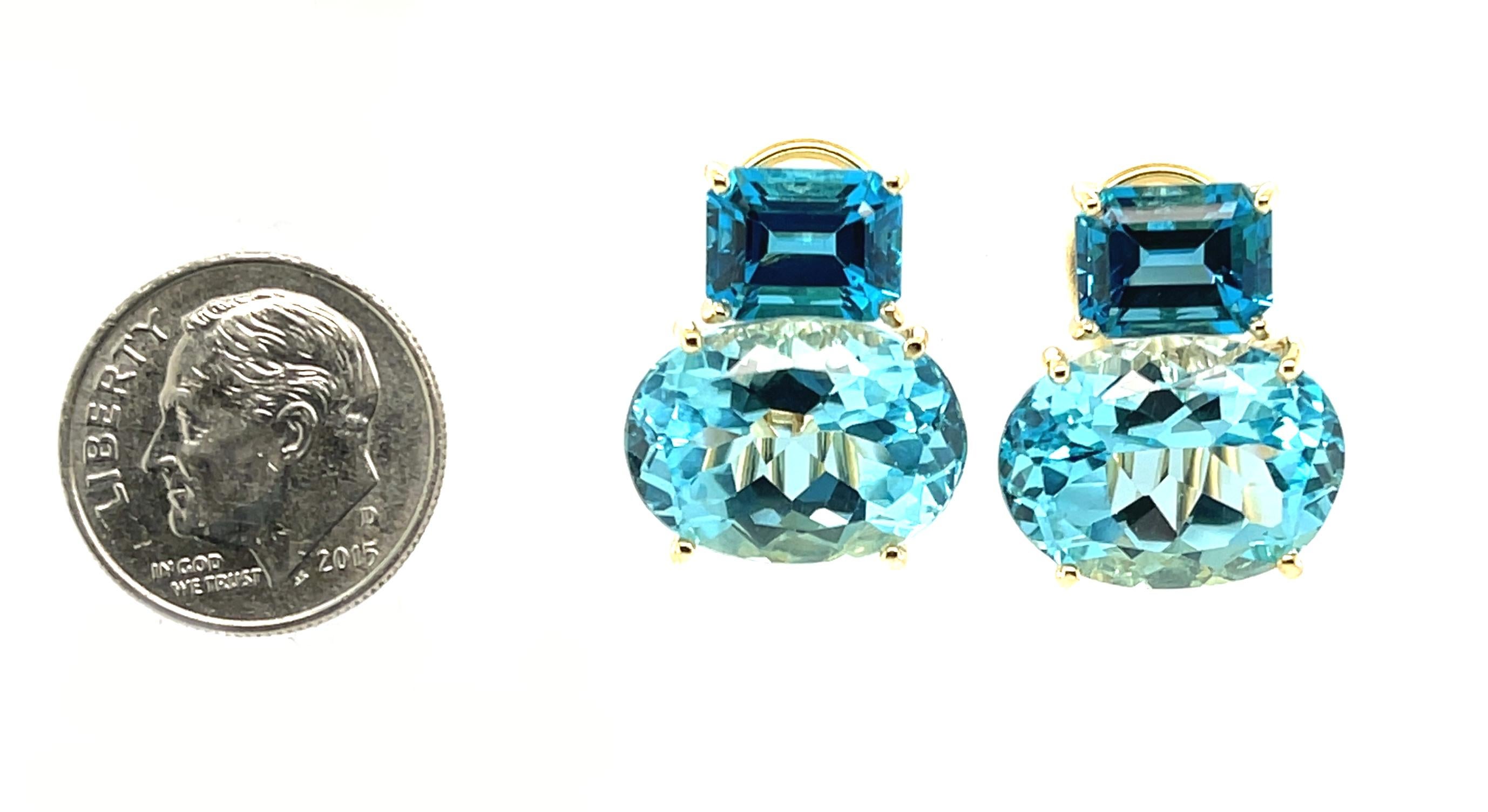 Diese atemberaubenden Ohrringe zeichnen sich durch helle, funkelnde Schweizer Blautopas-Ovale aus, gepaart mit tiefblauen Londoner Blautopas-Smaragdschliffen in einer herrlichen Farbblock-Kombination aus auffälligen Formen und Größen! Mit einer