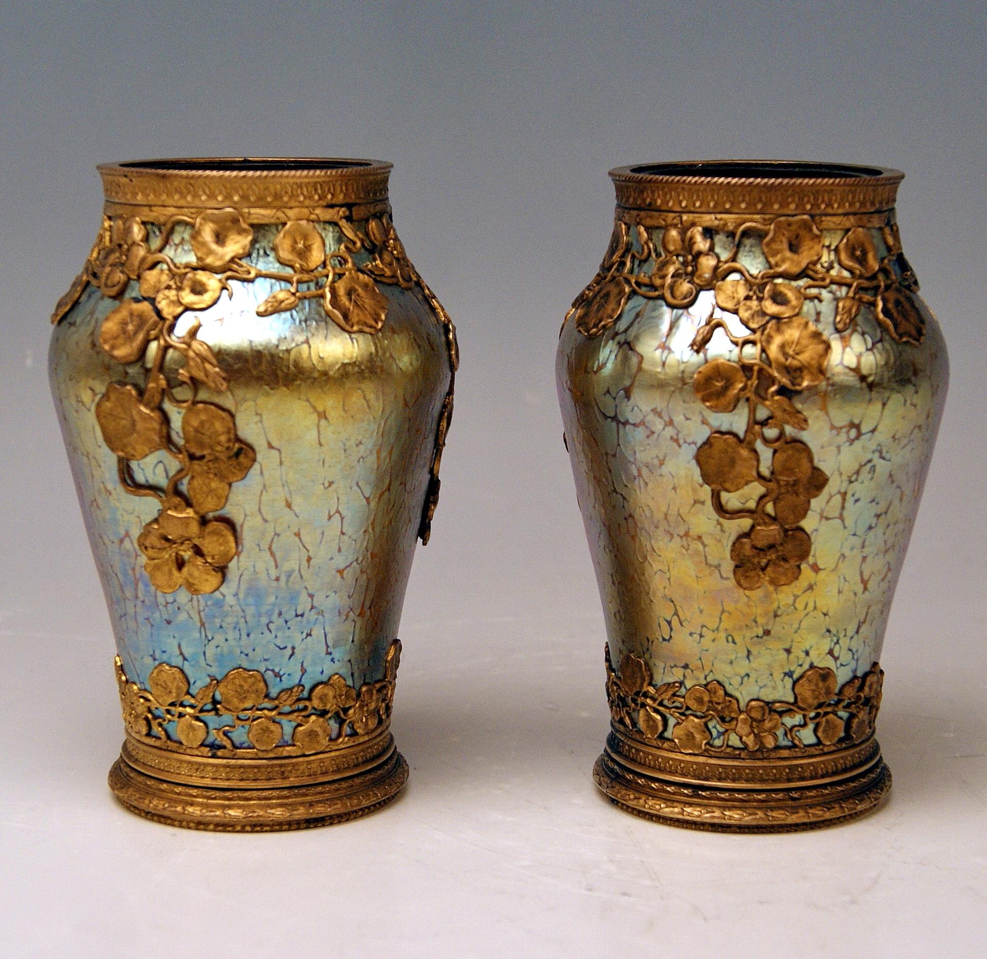 Pair of Art Nouveau vases
Made by Loetz (Lötz) Widow / Klostermuehle (Bohemia), circa 1905
Decor: Candia Papillon with bronze mountings / fittings
 
These are a finest pair of Loetz Art Nouveau vases of tapering type (slightly