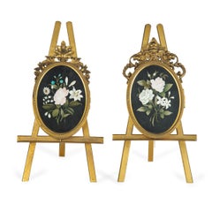 Two very similar pietra dura and ormolu photograph frames on easels