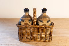 Two Victorian English Pottery Decanters in Tantalus-Inspired Wicker Basket