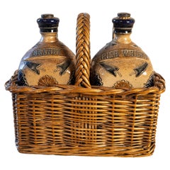 Two Victorian English Pottery Decanters in Tantalus-Inspired Wicker Basket