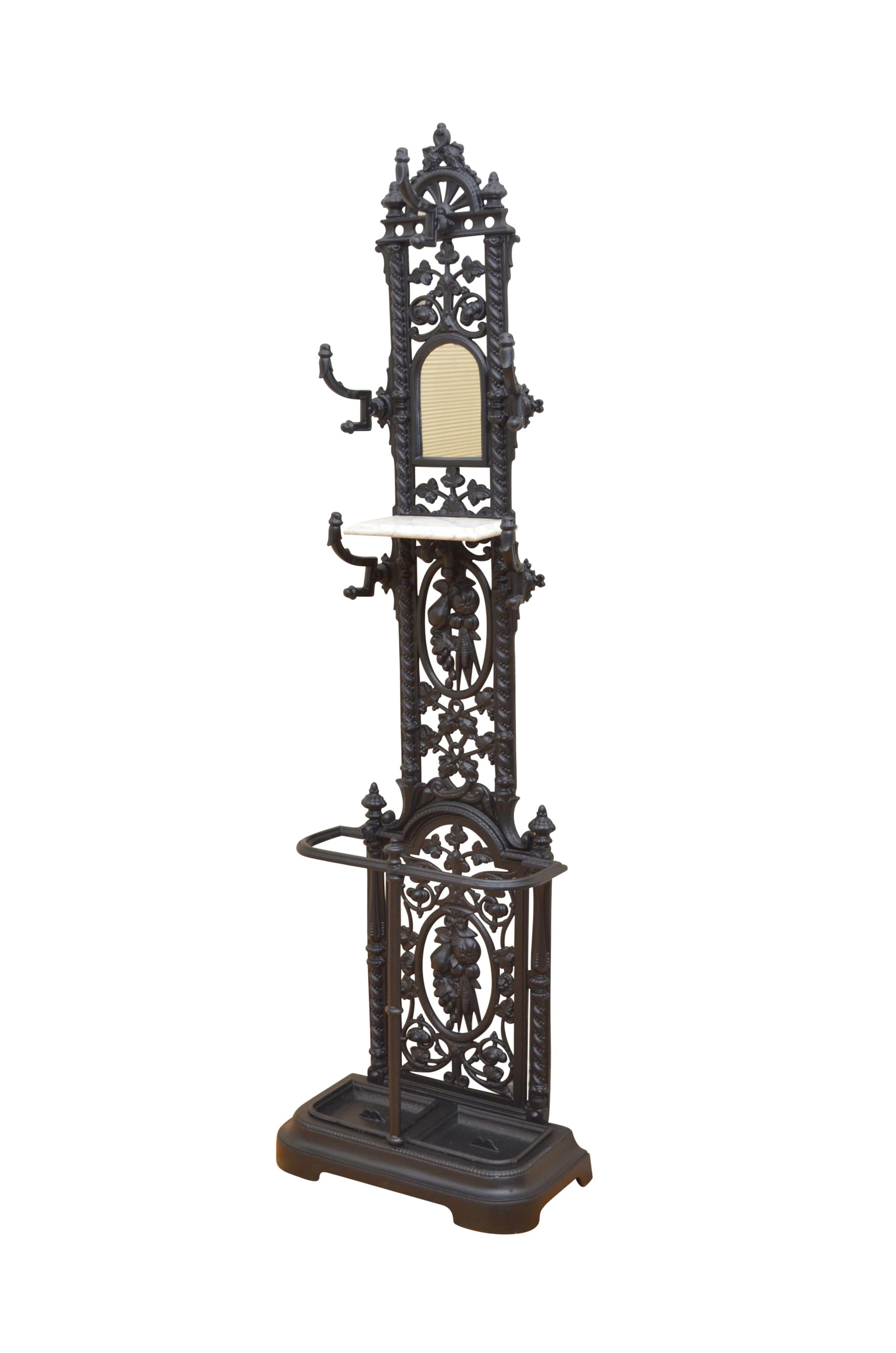 K0412 / K0386 Matched pair of Victorian cast iron hall stands, each with arched mirror to back and 5 coat hooks with marble shelf, over umbrella holder all with fruit and floral decoration throughout. This cast iron coat stand is in excellent