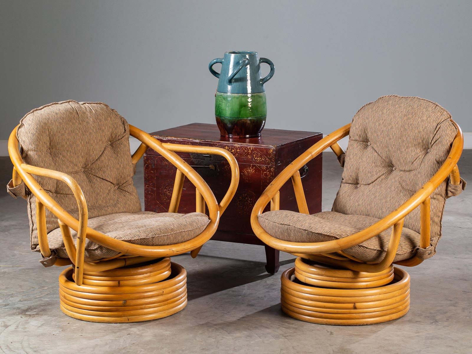 We love these vintage American bamboo swivel rocking chairs circa 1970 because they are awesomely comfortable. Having the original custom made upholstery these chairs were made to enclose you and never let you get up. Swivel side to side while