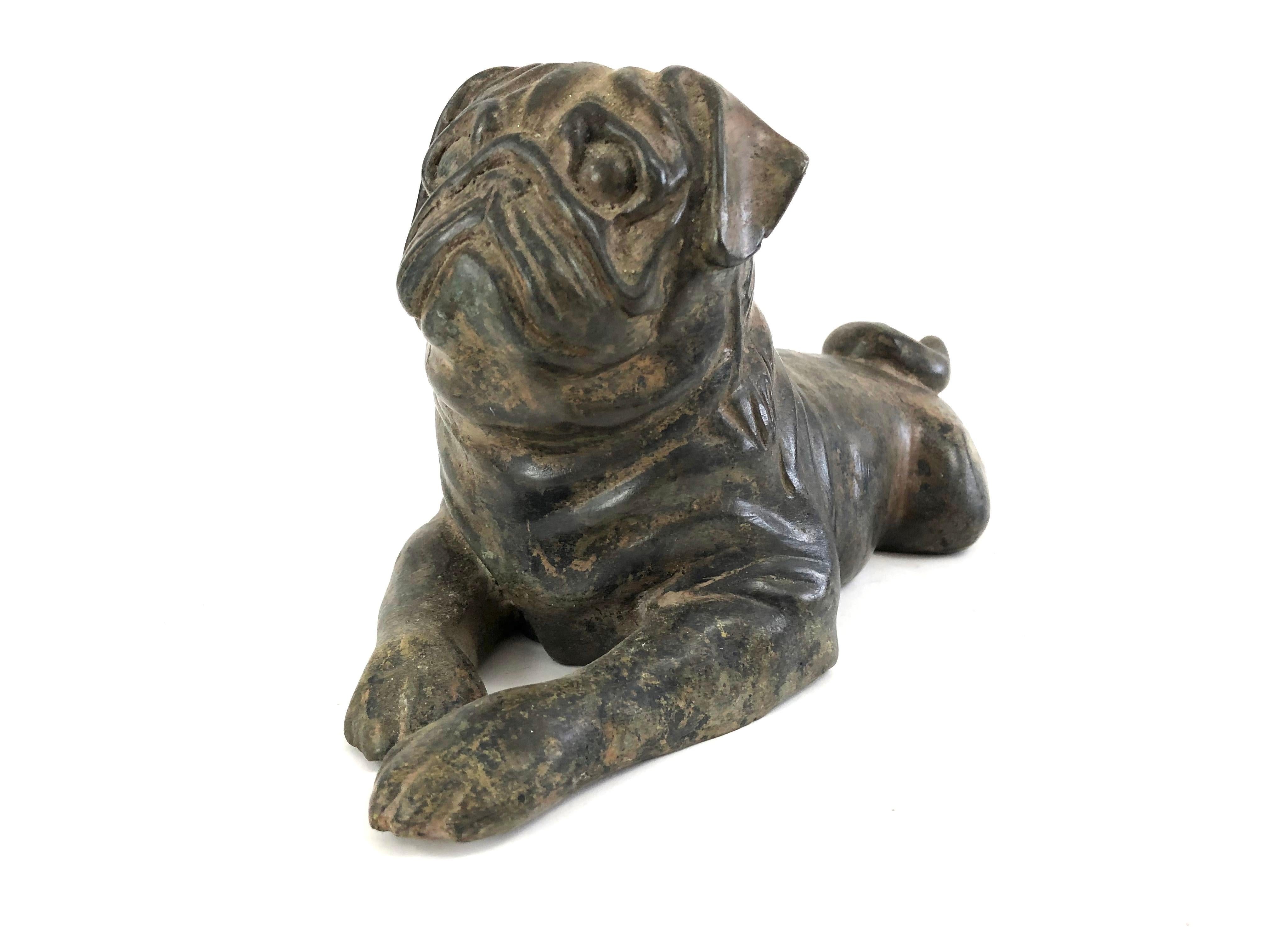 A well modeled and very charming pug in cast iron with traces of worn old gilded surface, lying down with paws in front and tucked in behind, head up with alert expression.

Perfect for pug, dog and animal lovers of all kinds.

Provenance: The