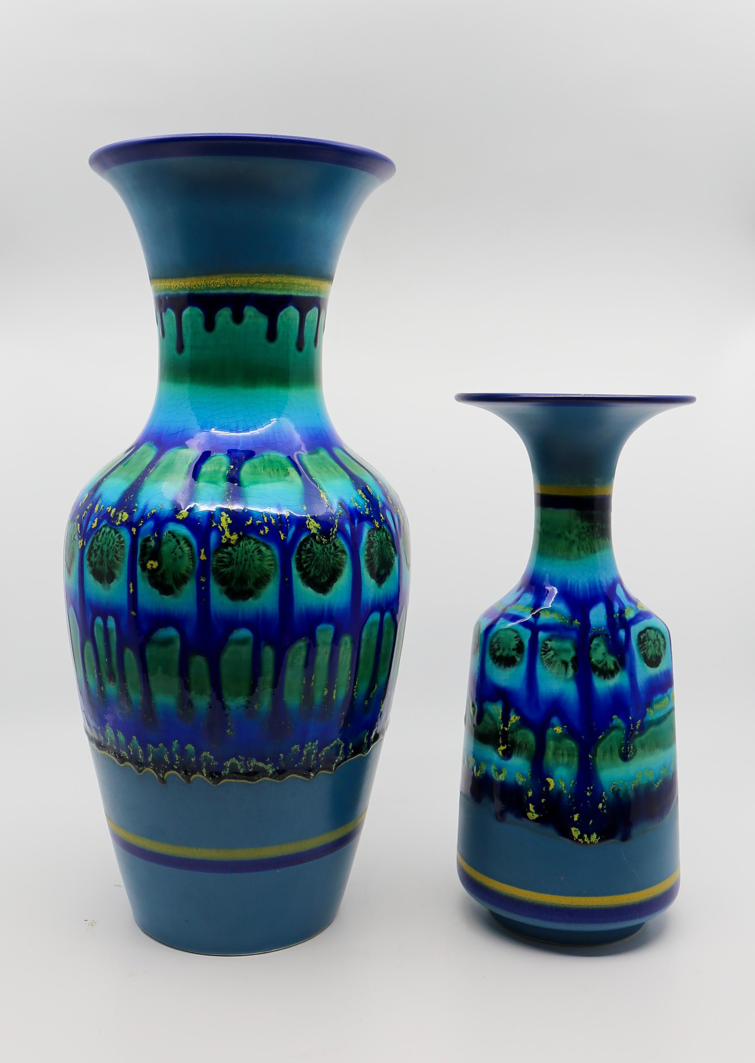 Two vintage blue ceramic fat lava style vases marked on base: Flora Holland.
Hand Painted.  

Height 38 cm. Diameter 17 cm.
Height 27 cm. Diameter 12 cm.
Please note that price is per item not for the set.

Flora Holland - Gouda porcelain factory