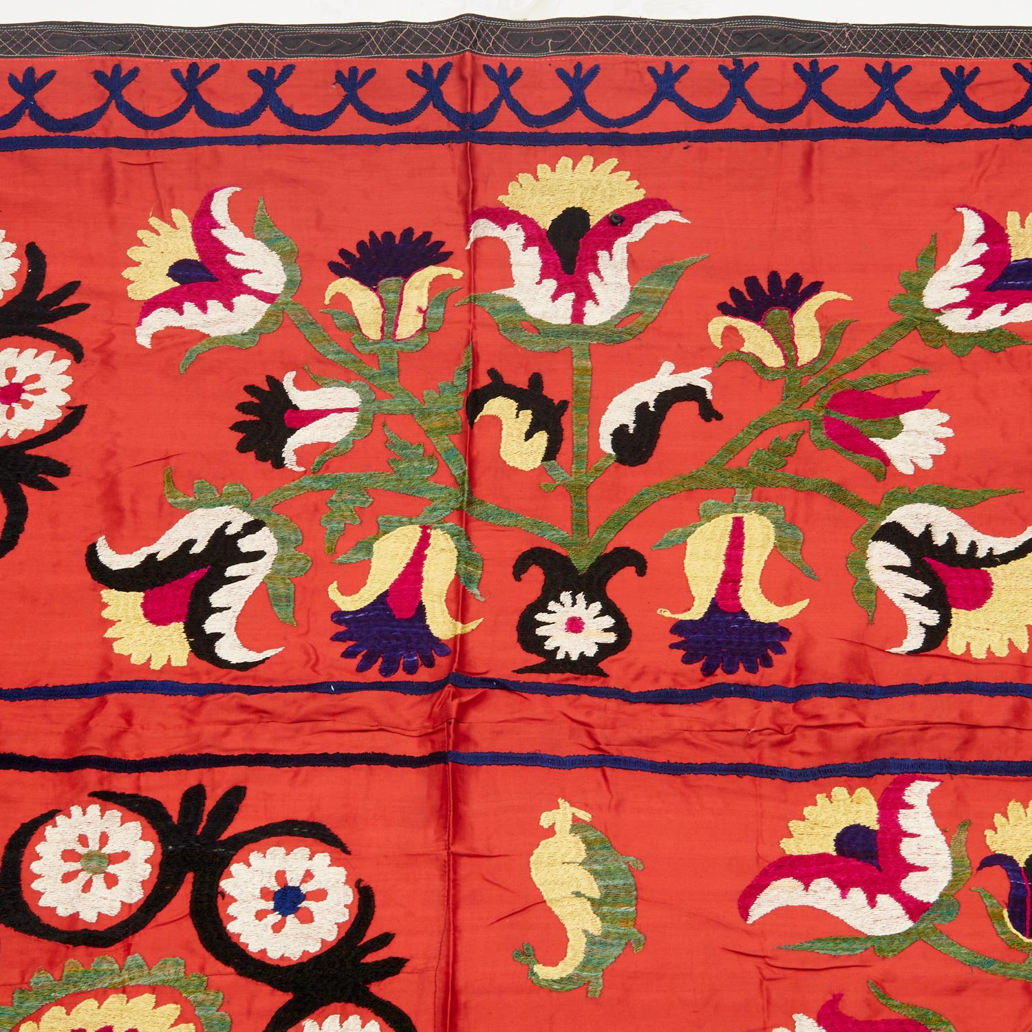 From the collection of visual artist Lewis Stein, NYC, two late 20th c., embroidered Suzani style textiles, probably Uzbekistan, each with colorful embroidered floral design, the larger example with embroidered text and yellow fringe.