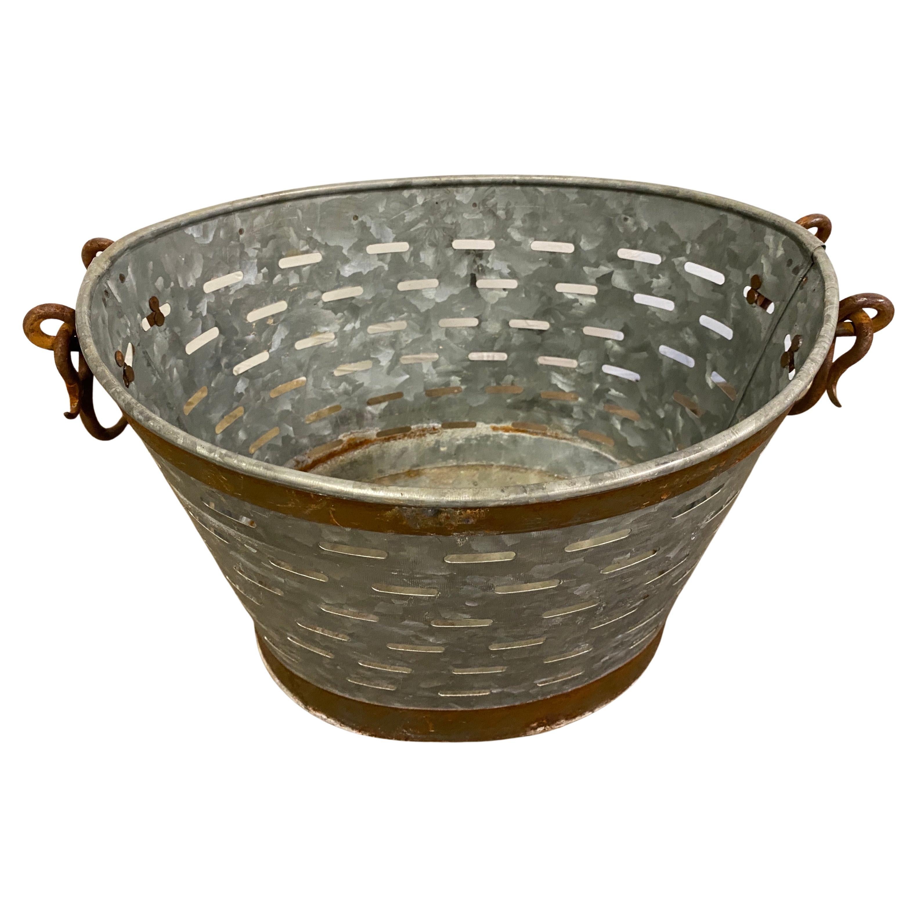 Two vintage galvanized olive buckets or baskets, not a matching pair but used them together or separate for a waste basket, storage baskets, planters or a catch all. These particular baskets have wonderful copper tone bands giving them added