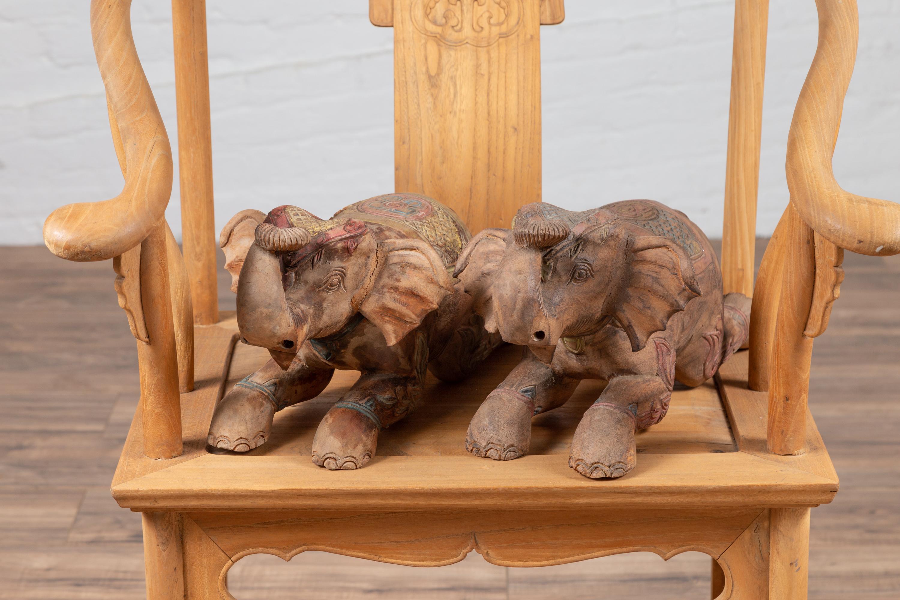Two vintage Thai handmade carved elephant sculptures from Chiang Mai, with slight variations. They are priced and sold individually. Born in Northern Thailand during the mid-century period, each of these two small sculptures depicts an elephant,