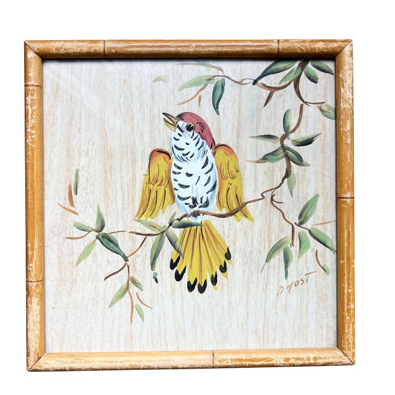 A pair of chinoiserie faux bamboo watercolor paintings of birds. This lovely set was quite the find. We fell in love with the faux bamboo bird frame immediately. Each painting is signed by the artist D. Yost, and framed in a custom wood frame with