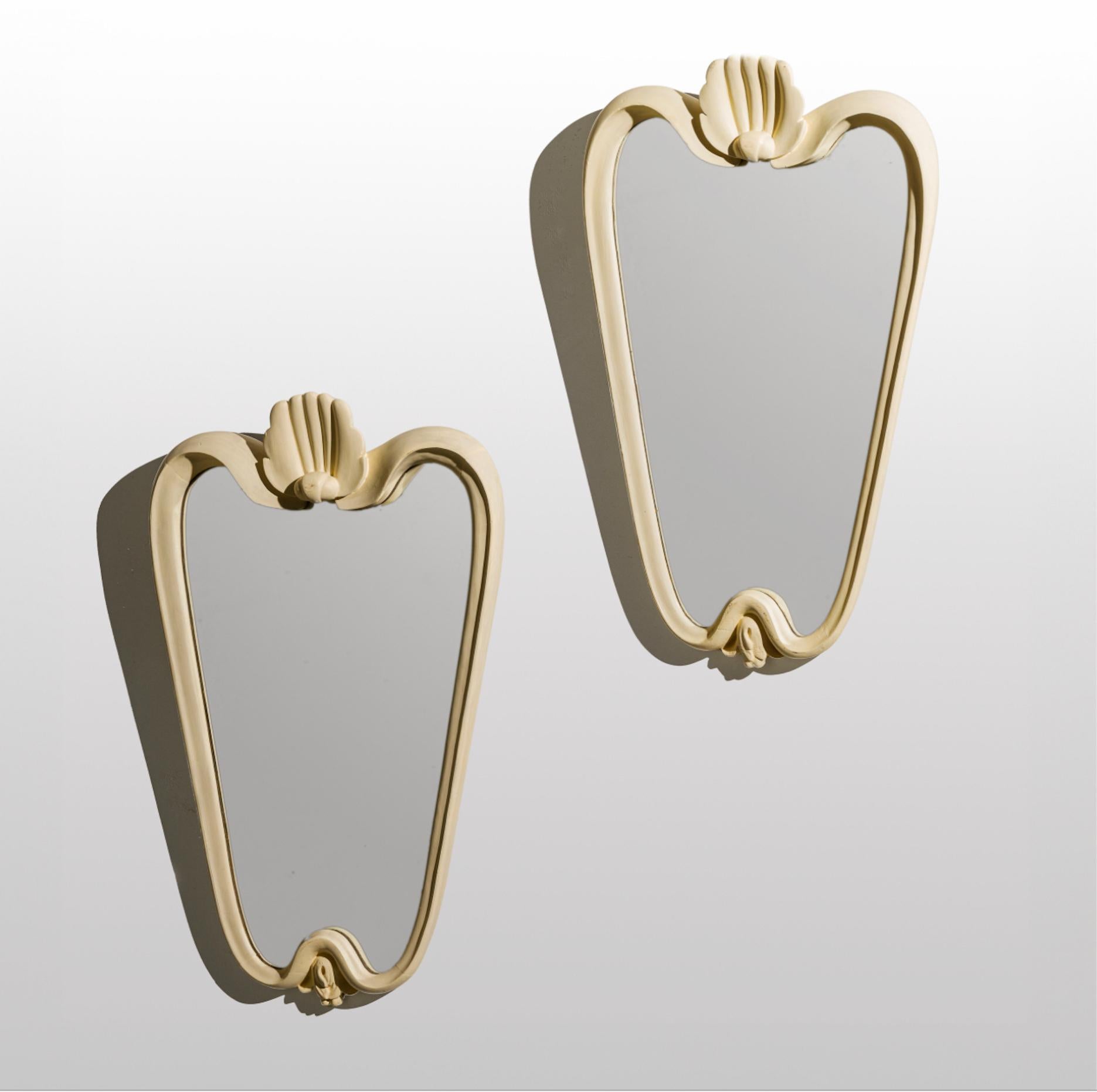Deux rares miroirs Mid-Century en bois sculpté laqué, verre miroir, dans le style du grand architecte et designer italien Osvaldo Borsani. 1940s.

Les œuvres proviennent d'un important hôtel de Florence et conservent tout leur style et leur charme.