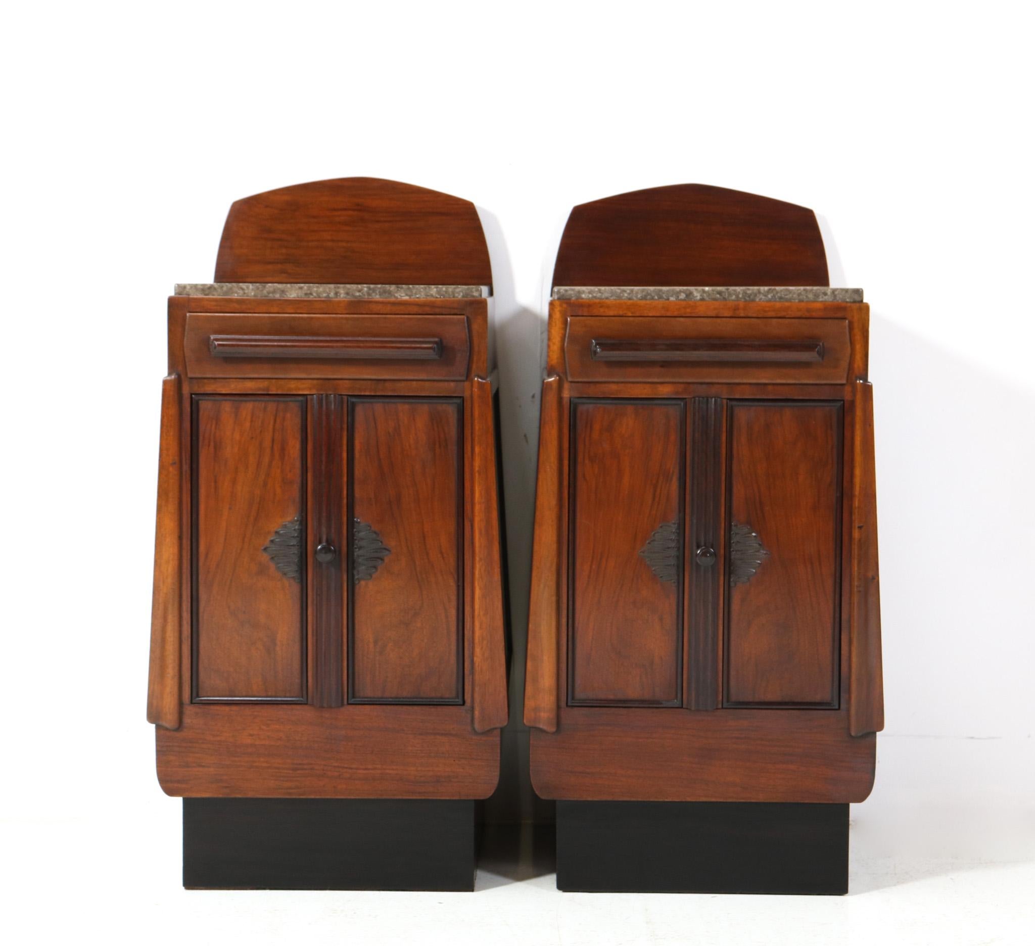 Magnificent and rare pair of Art Deco Amsterdamse School nightstands or bedside tables.
Striking Dutch design from the 1920s.
Solid walnut base with solid macassar ebony decorative elements.
This wonderful pair of Art Deco Amsterdamse School
