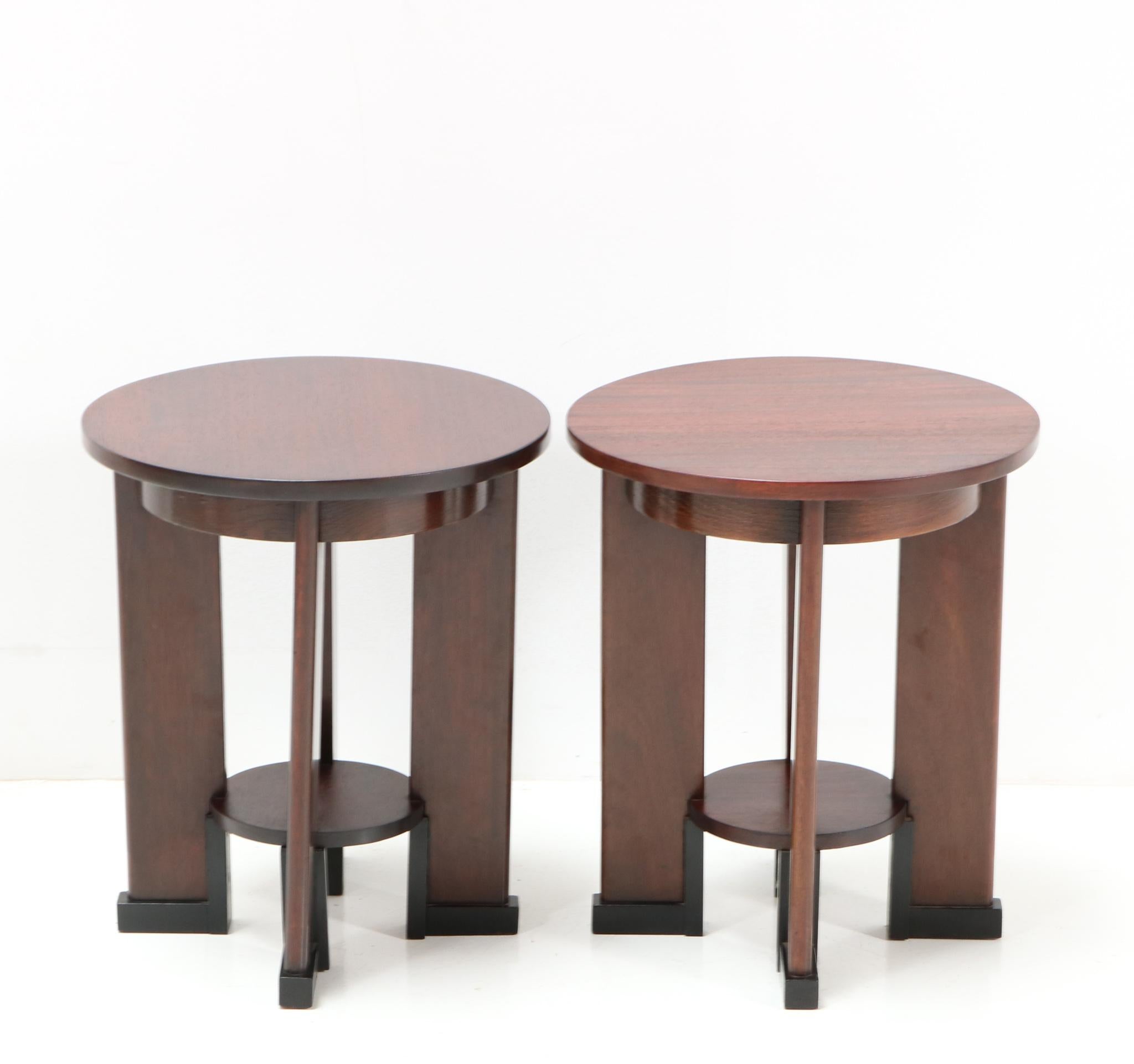 Magnificent and rare pair of Art Deco Amsterdamse School side tables.
Design by J.J. Zijfers Amsterdam.
Striking Dutch design from the 1920s.
Solid walnut base with solid walnut top.
Original black lacquered lining.
This wonderful pair of Art