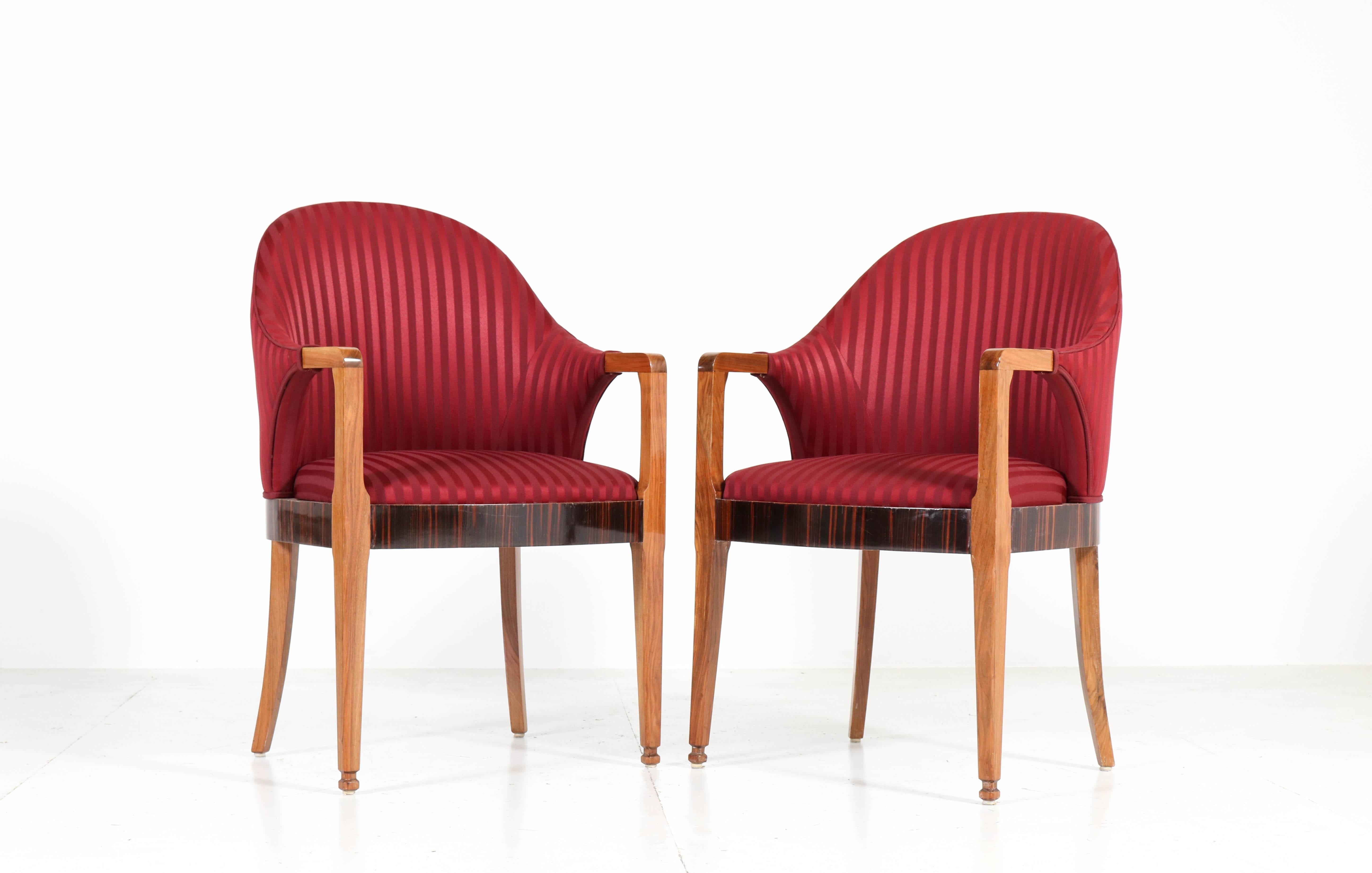 Wonderful pair of Art Deco armchairs.
Striking French design from the 1930s.
Solid walnut with ebony Makassar veneer lining.
Re-upholstered with red striped fabric.
In good original condition with minor wear consistent with age and