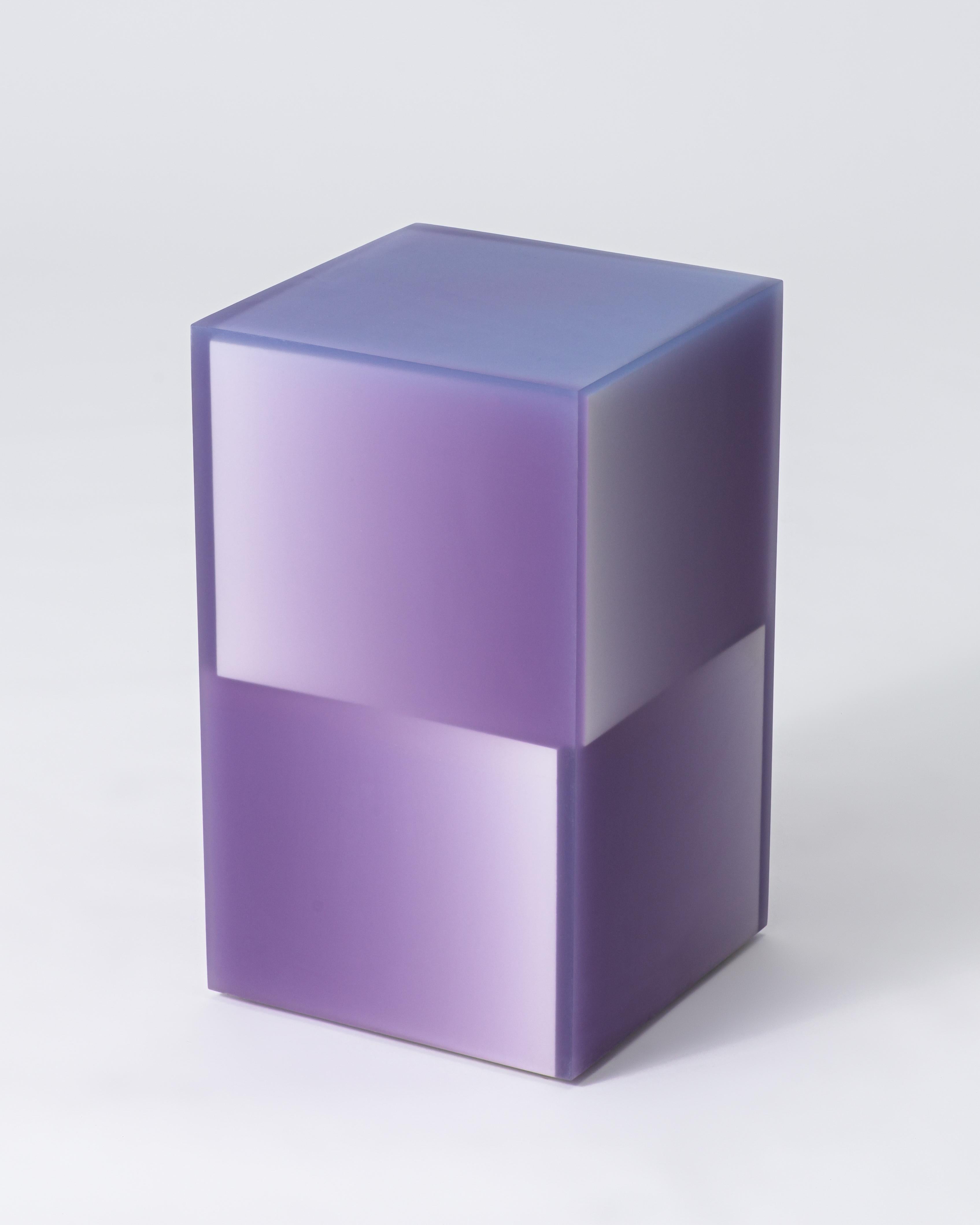 This playful multi-layered side table with a stacked cube design is available in different gradients of five primary colors. Created with a medley of gradual saturation shifts in opposing directions, the combination of core and resin color