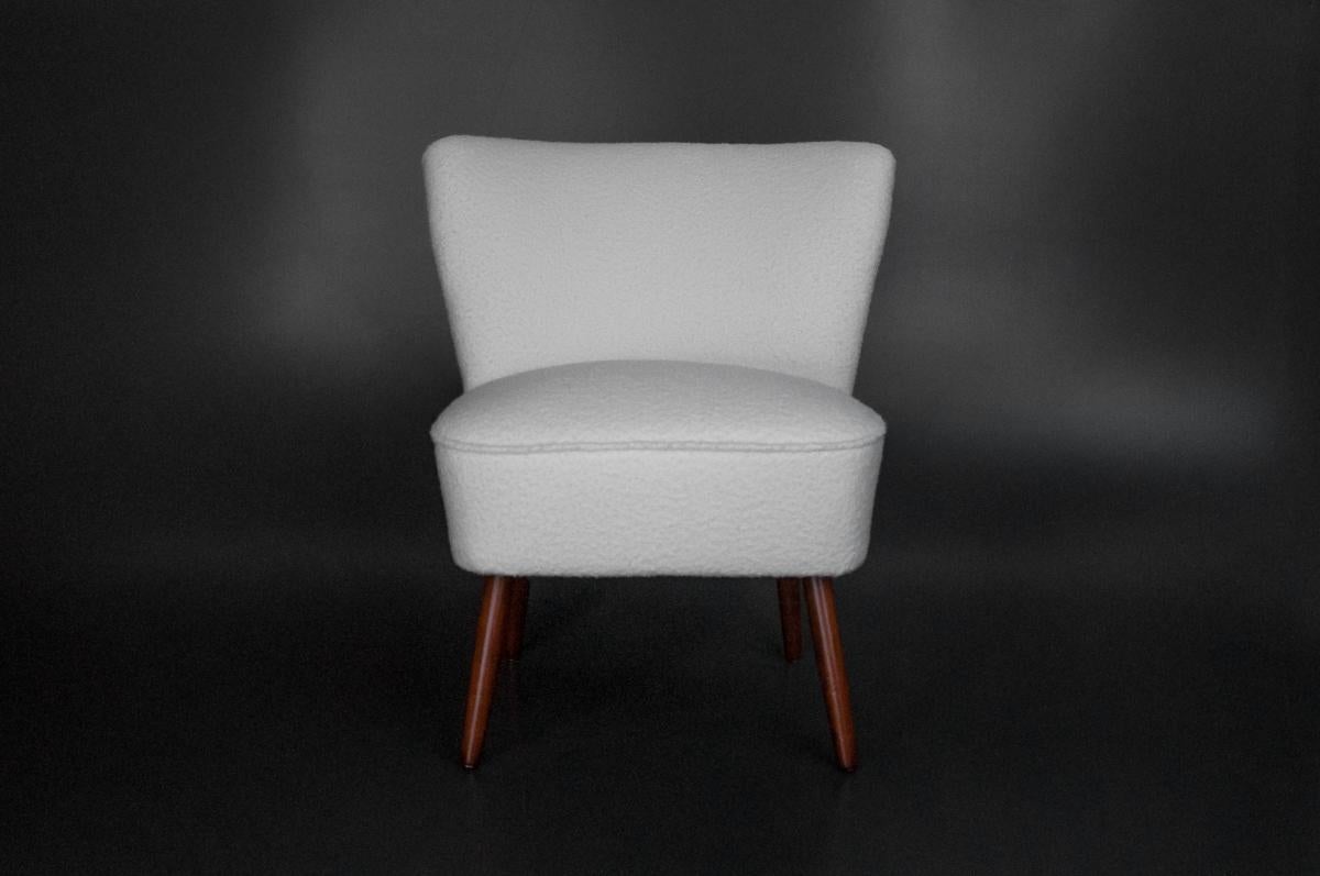 Two unique club chairs from mid-20th century.
After professional restoration, white boucle cozy soft material in white color.
Wooden legs.
Excellent condition.