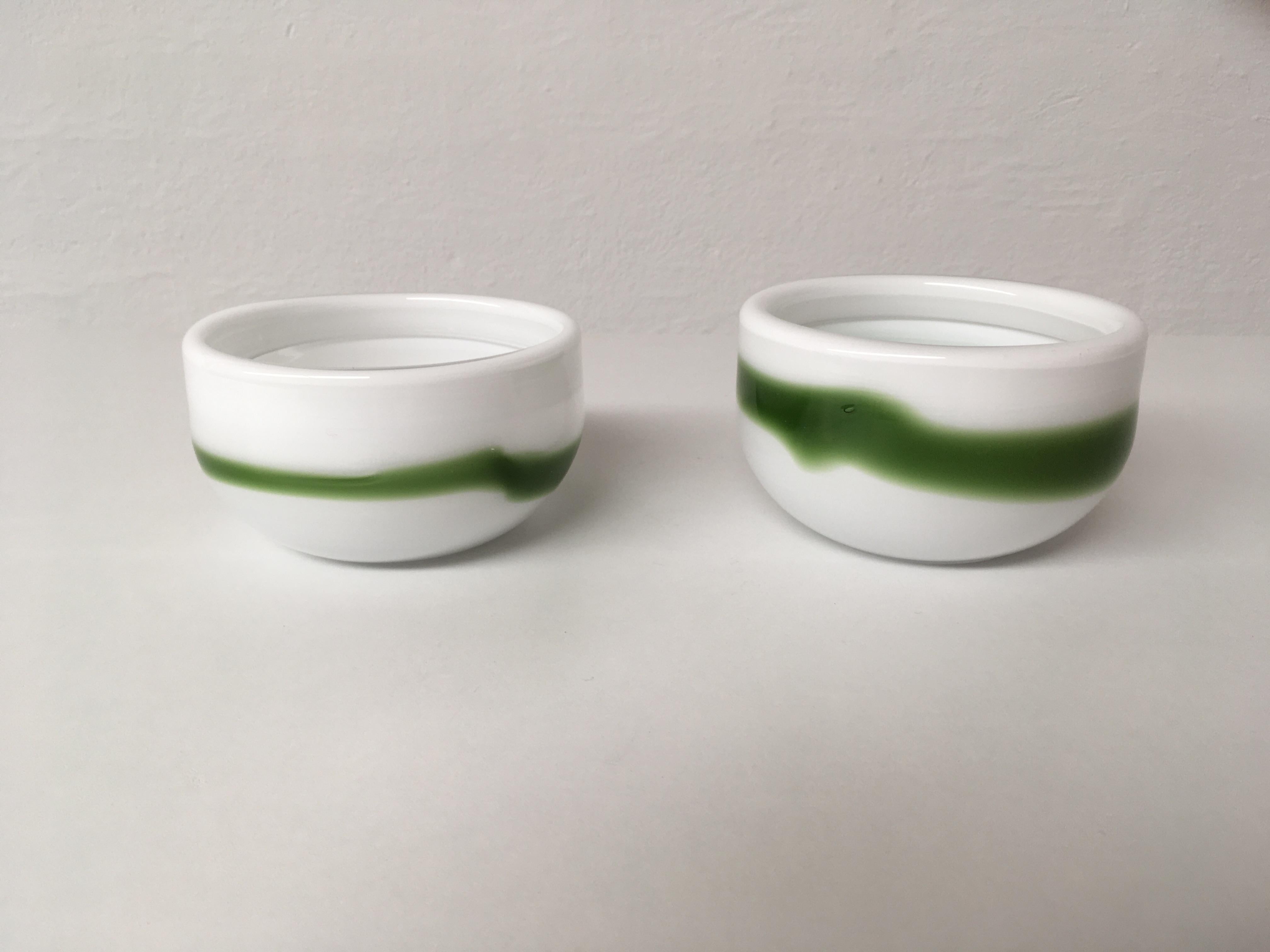 Set of two white and green Danish bowls in handblown opaline glass, designed by Michael Bang and produced by Holmegaard in the 1970s.

The well designed set with it´s 1970´s colors made in 3 layers opaline glass is in very good condition with only