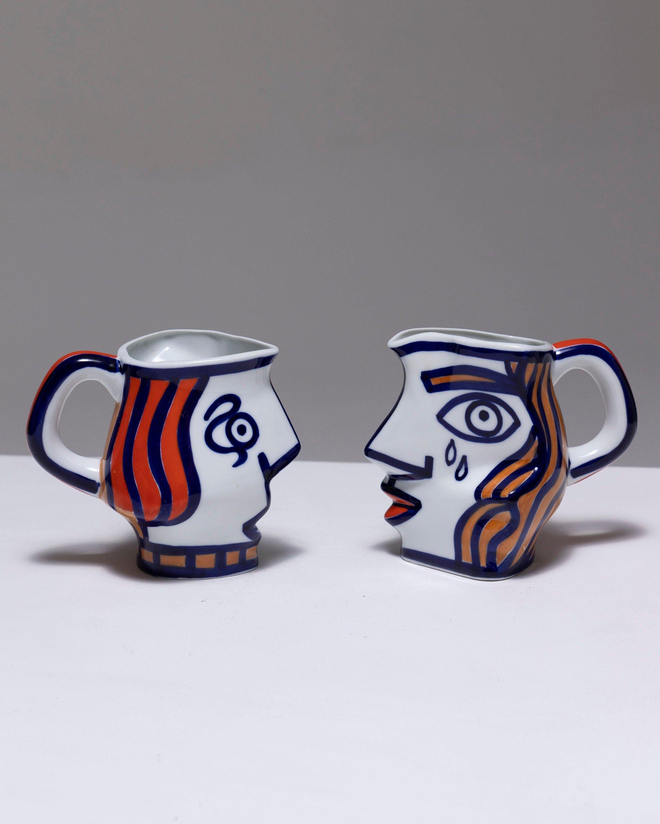 Two Yin-Yang Porcelain Pitchers by O. Castro, 2000s. Featuring a decor of faces painted in cobalt blue, with ochre and orange accents. Signed on the underside: 'O. Castro / Galicia-Spain' in blue and numbered '385.' In excellent condition.
DV1366