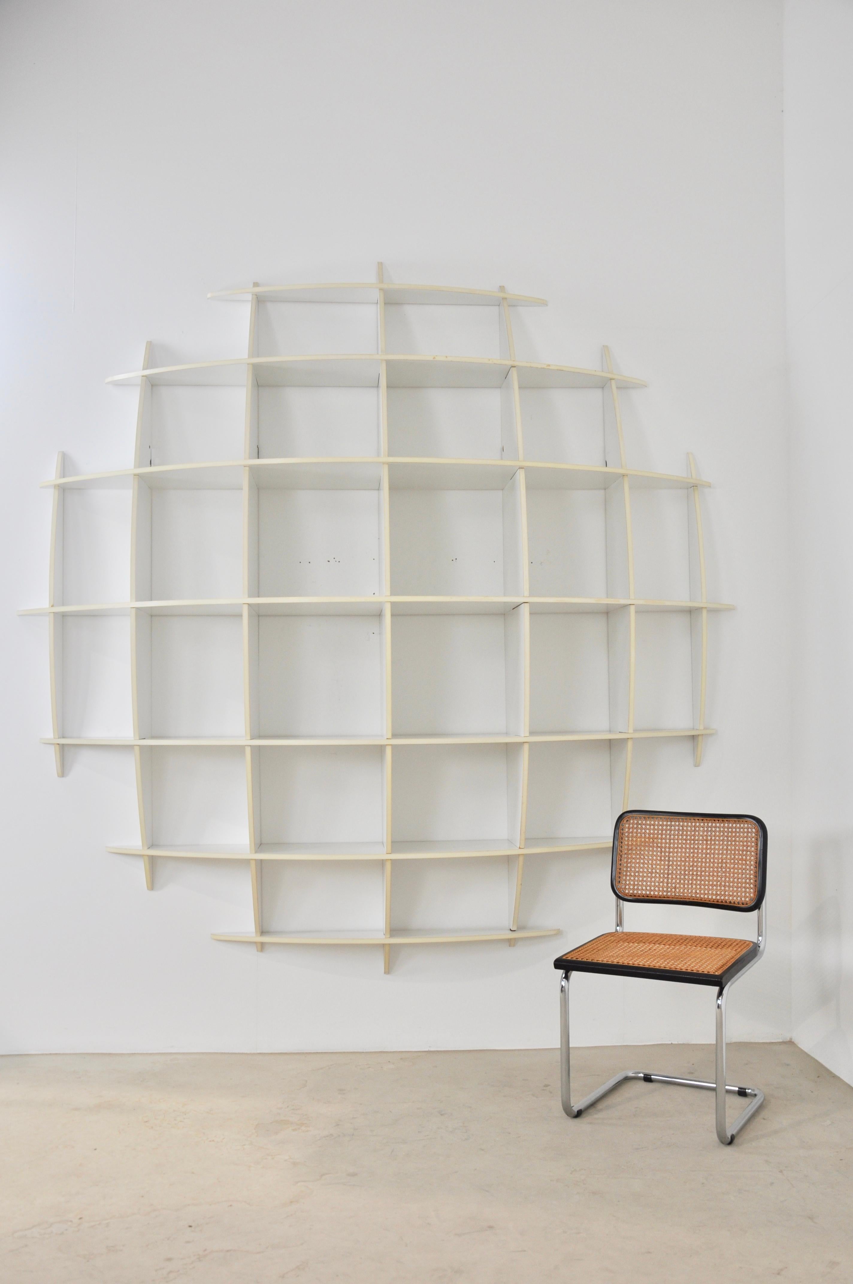 White wooden bookcase. Wear due to time and the age of the bookcase.