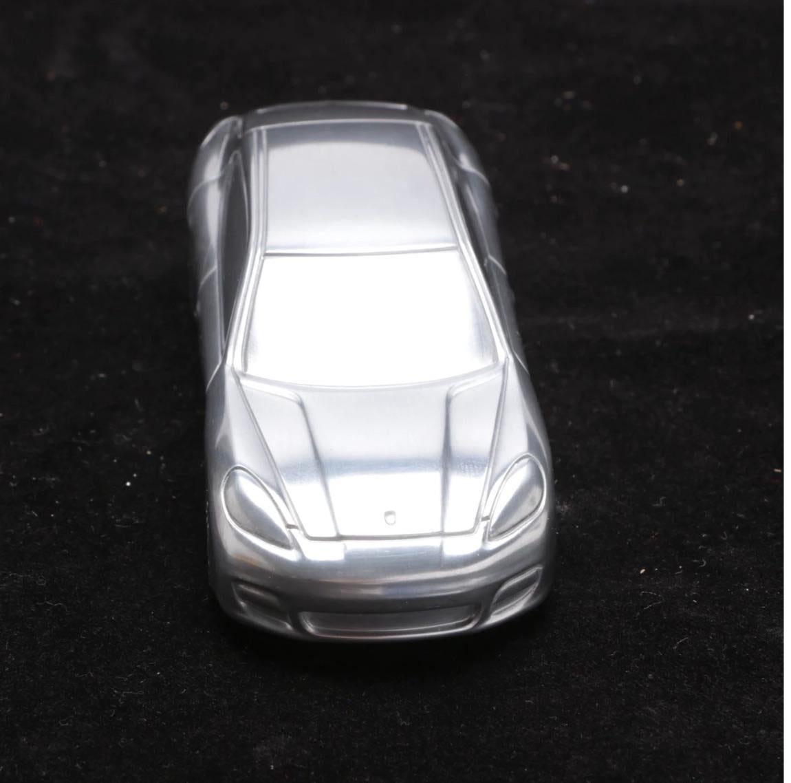 A great gift for your man!!!
A shiny silver tone solid metal Porsche limited edition model of the Panamera Turbo in the original conforming black box.
This was given to a Tycoon automobile collector when he purchased the Porsche, so models were