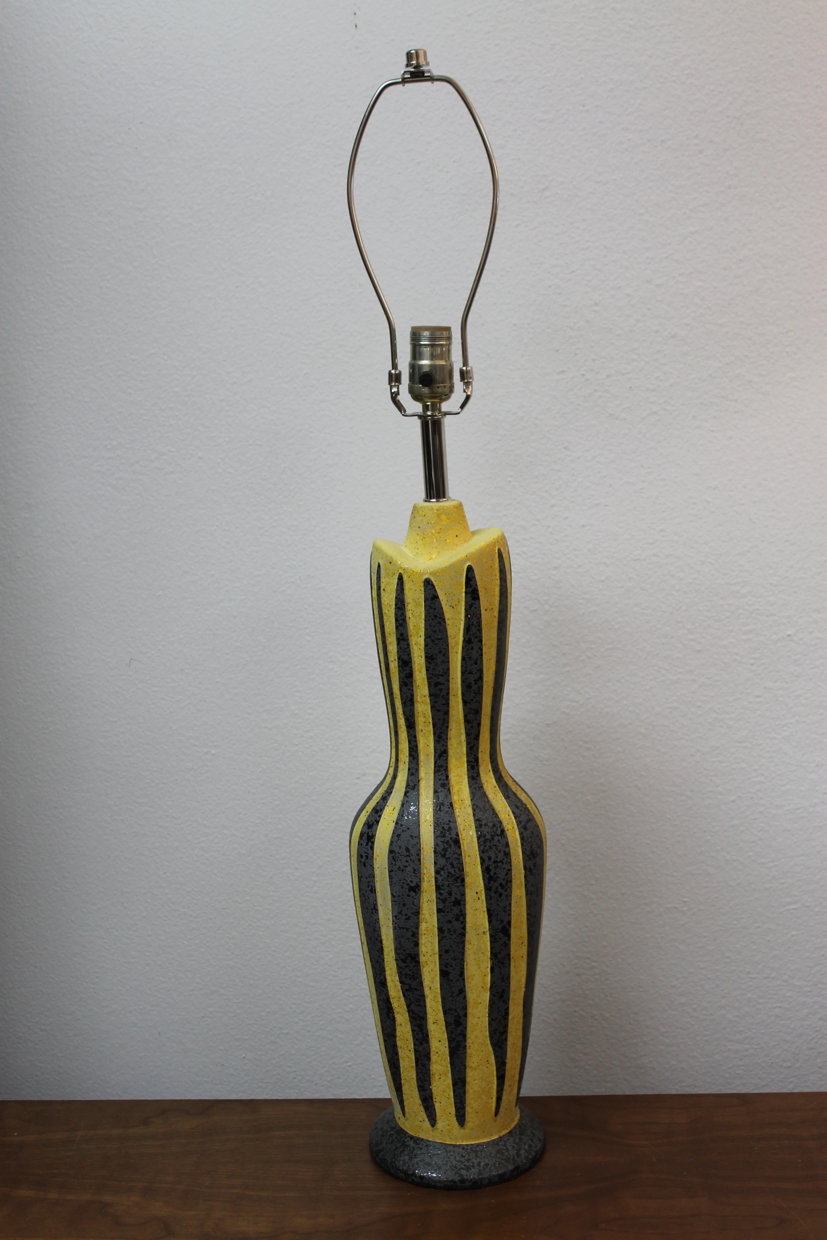 A circa 1955 ceramic lamp with typical Tye of California glaze, a matte mottled yellow with grey stripes. Signed on the base 