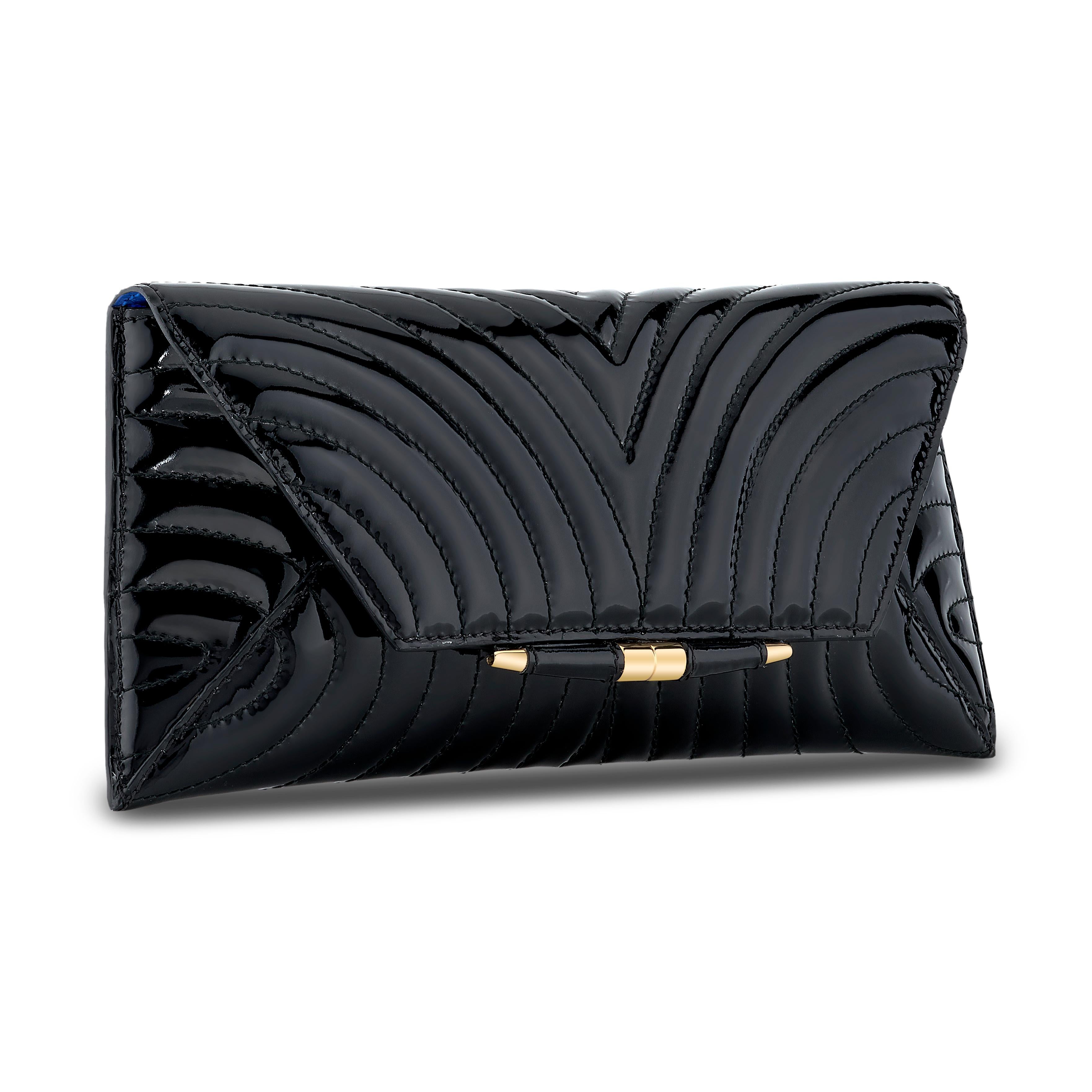 The Aimee in Black Custom Quilted Patent Leather with gold hardware is a clutch designed with a three-quarter front flap, a magnetic snap closure and is finished with our custom Infinity Bar. It fits the large iPhone, has a hidden exterior pocket,