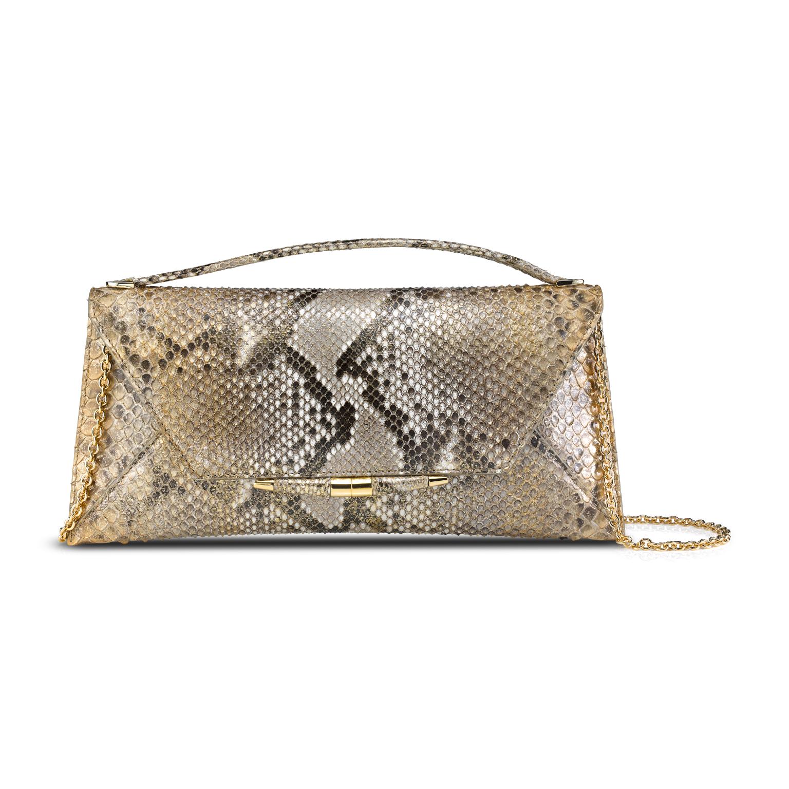 The Aimee clutch large is featured in Metallic Gold Natural Python with gold hardware. The clutch is designed with a top handle, three-quarter front flap, a magnetic snap closure and is finished with our custom Infinity Bar. It fits the large