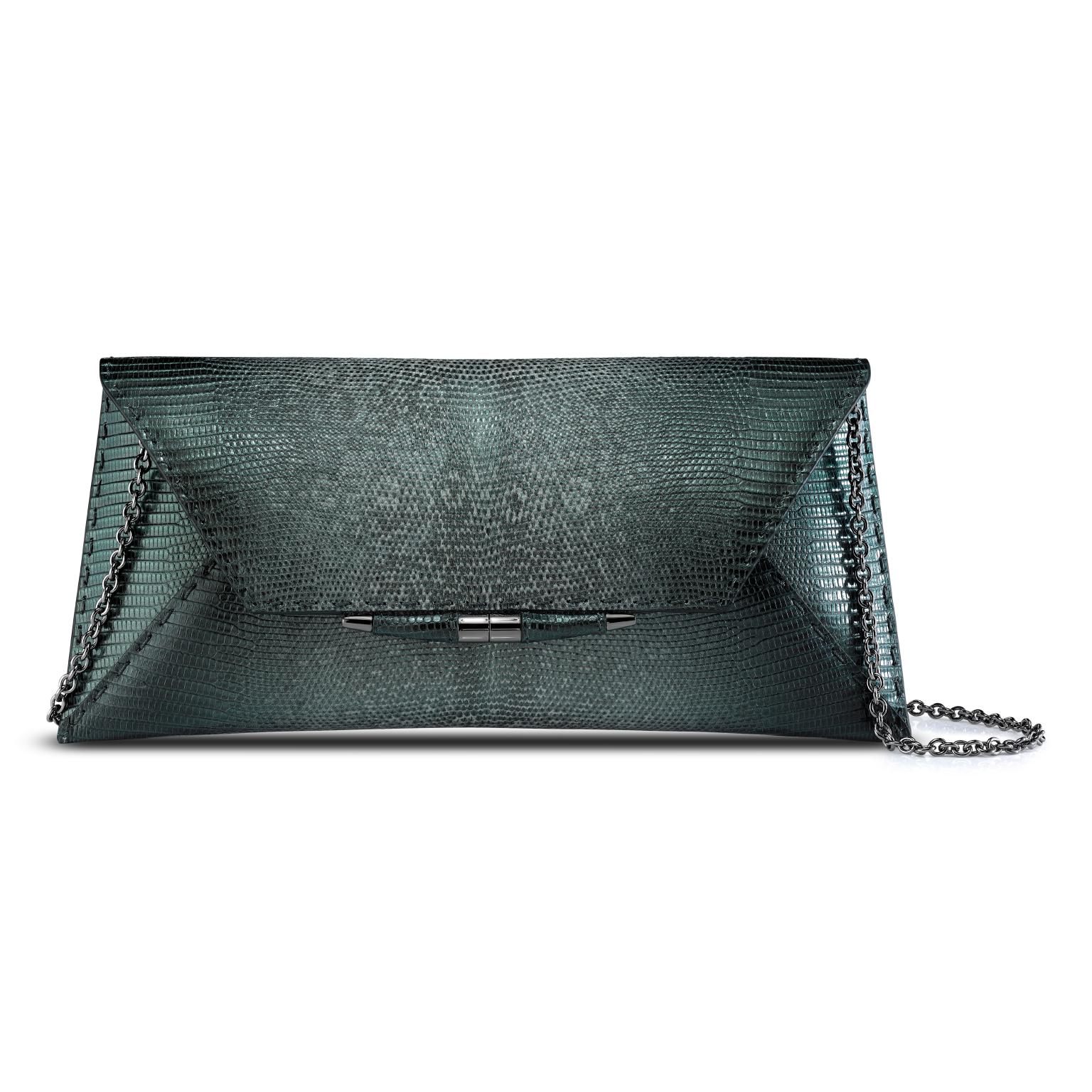 The Aimee Clutch large is featured in our Peacock Lizard with gunmetal hardware. The clutch is designed with a three-quarter front flap, a magnetic snap closure and is finished with our custom Infinity Bar. It fits the large iPhone, has a hidden