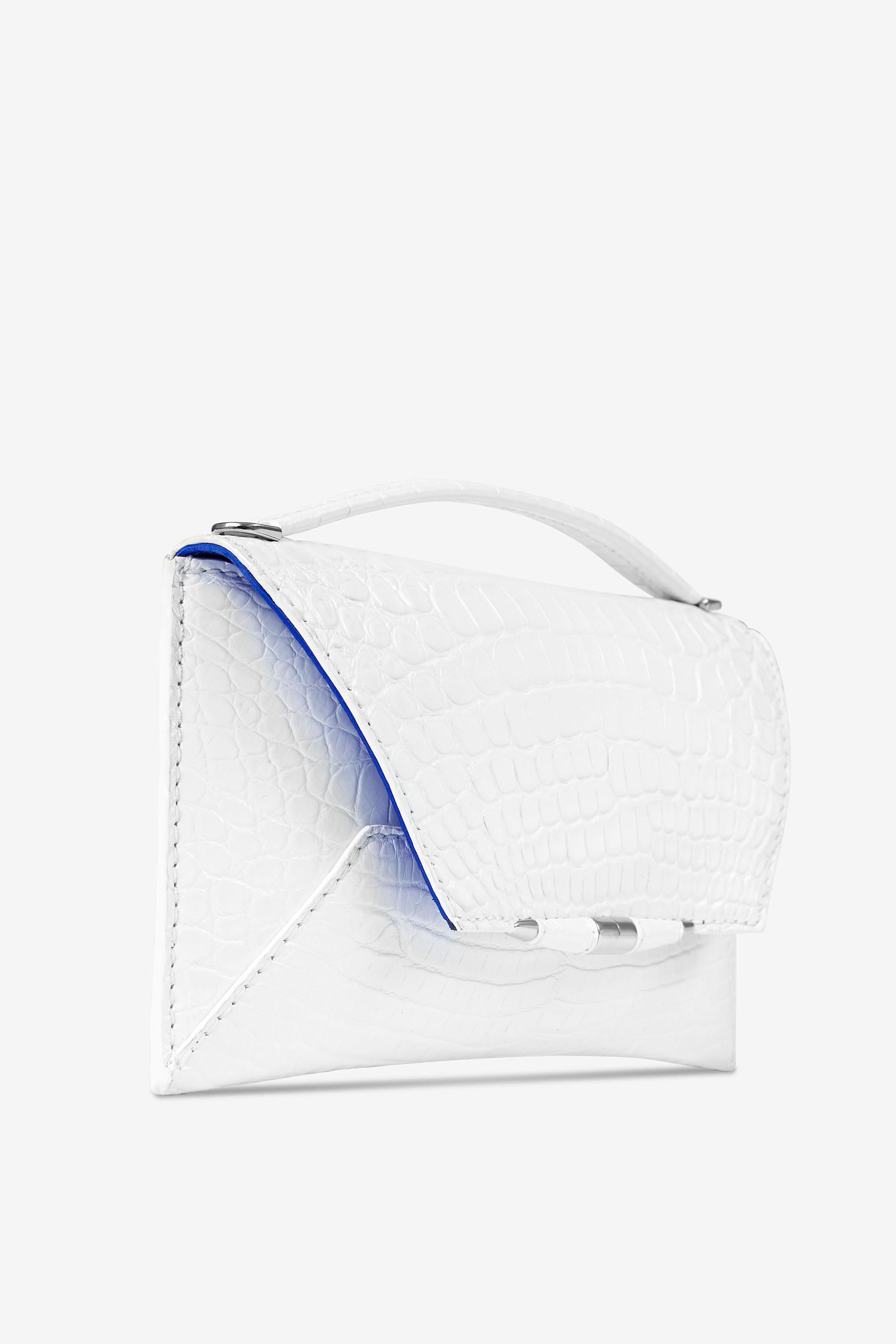 The Aimee Clutch Large White Alligator Silver Hardware is designed with a magnetic front flap snap closure, hidden exterior pocket and a detachable cross-body White Alligator strap. It features our custom infinity bar closure and signature Thayer