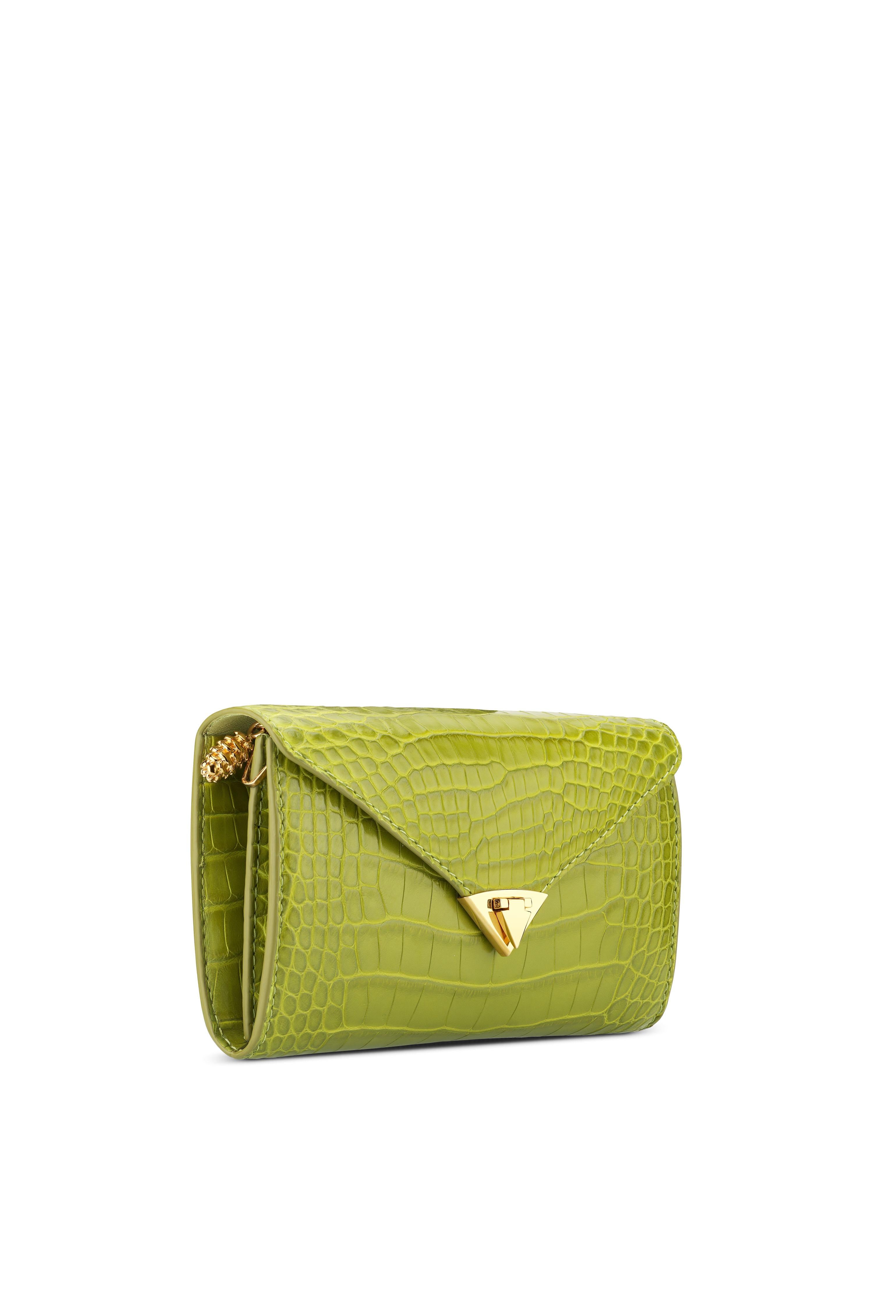 The Alex Wallet Olive Martini Alligator Gold Hardware is designed with a detachable gold cross-body chain, interior credit card slots and a pinecone pull zip pocket. It features our signature spear-lock closure and Thayer blue leather lining.

Size: