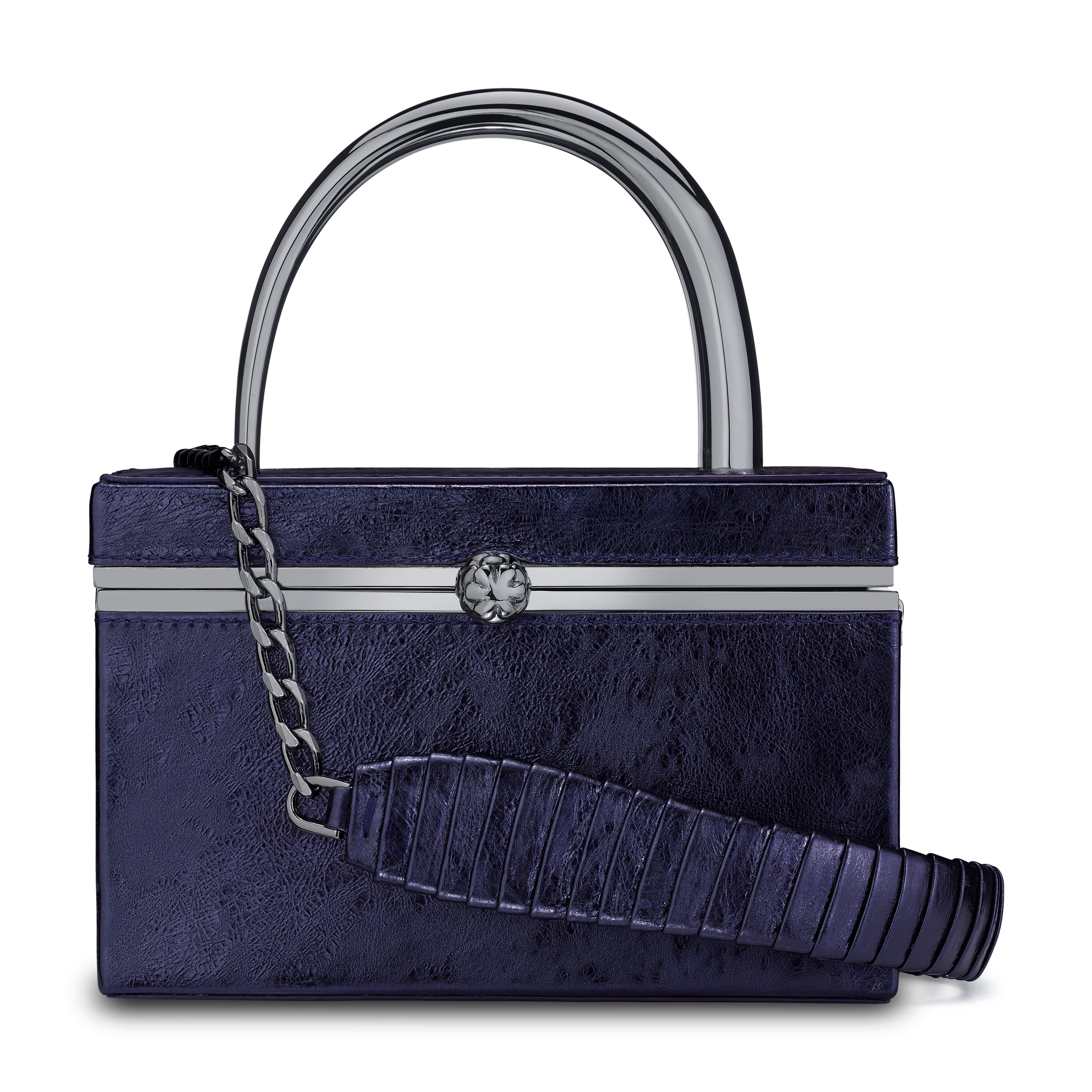 The Ava Box is featured in Sapphire Antiqued Leather with gunmetal hardware. The hard-framed rectangular box is designed with our custom horn-shaped metal handle and an optional cross-body chain with a matching leather wrapped accent. It fits the