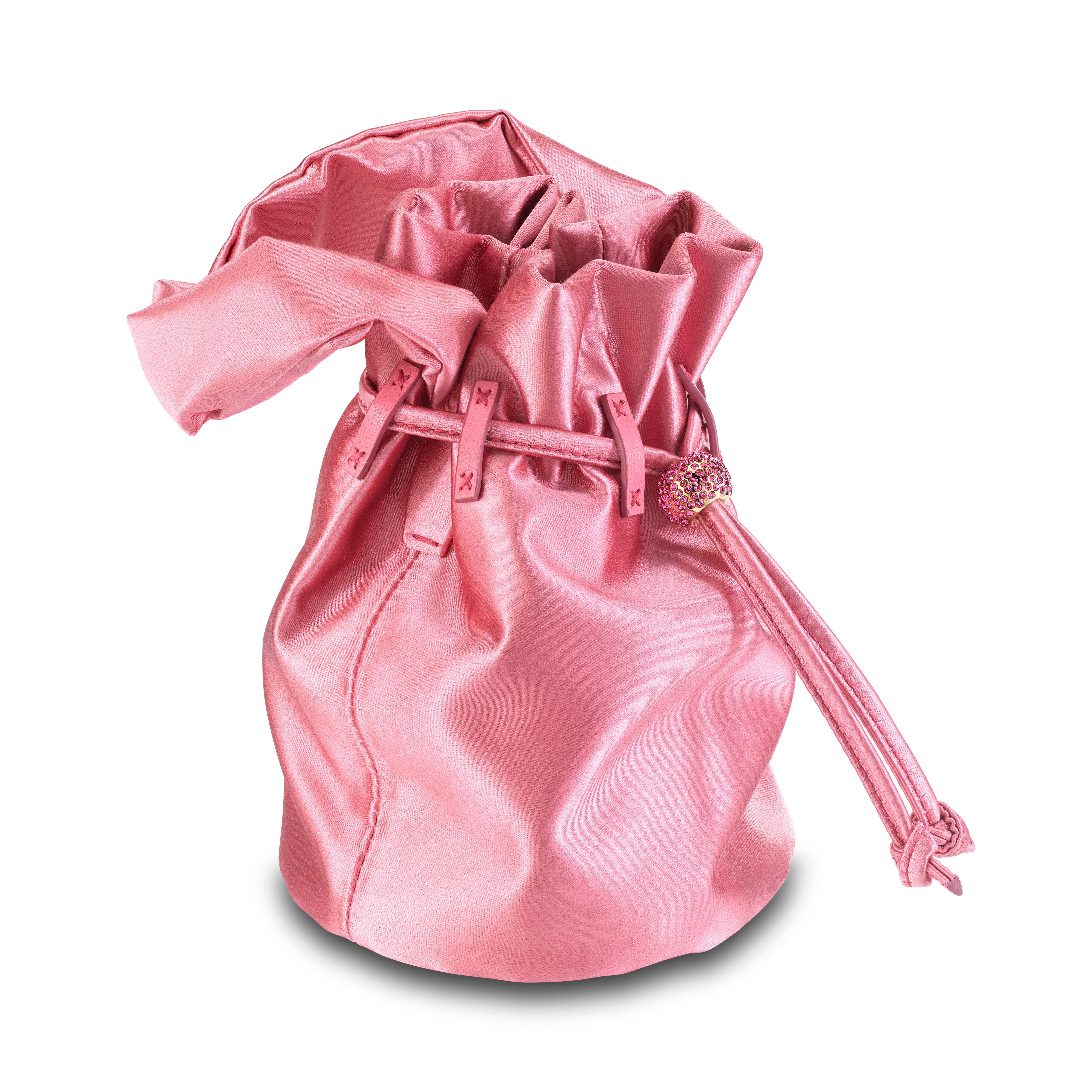 The Grace Mini is featured in our Bubblegum satin. This soft pouch has a satin handle and drawstring closure. The closure is embellished with Swarovski crystals and gold hardware. It fits the large iPhone, has interior card slots and features our