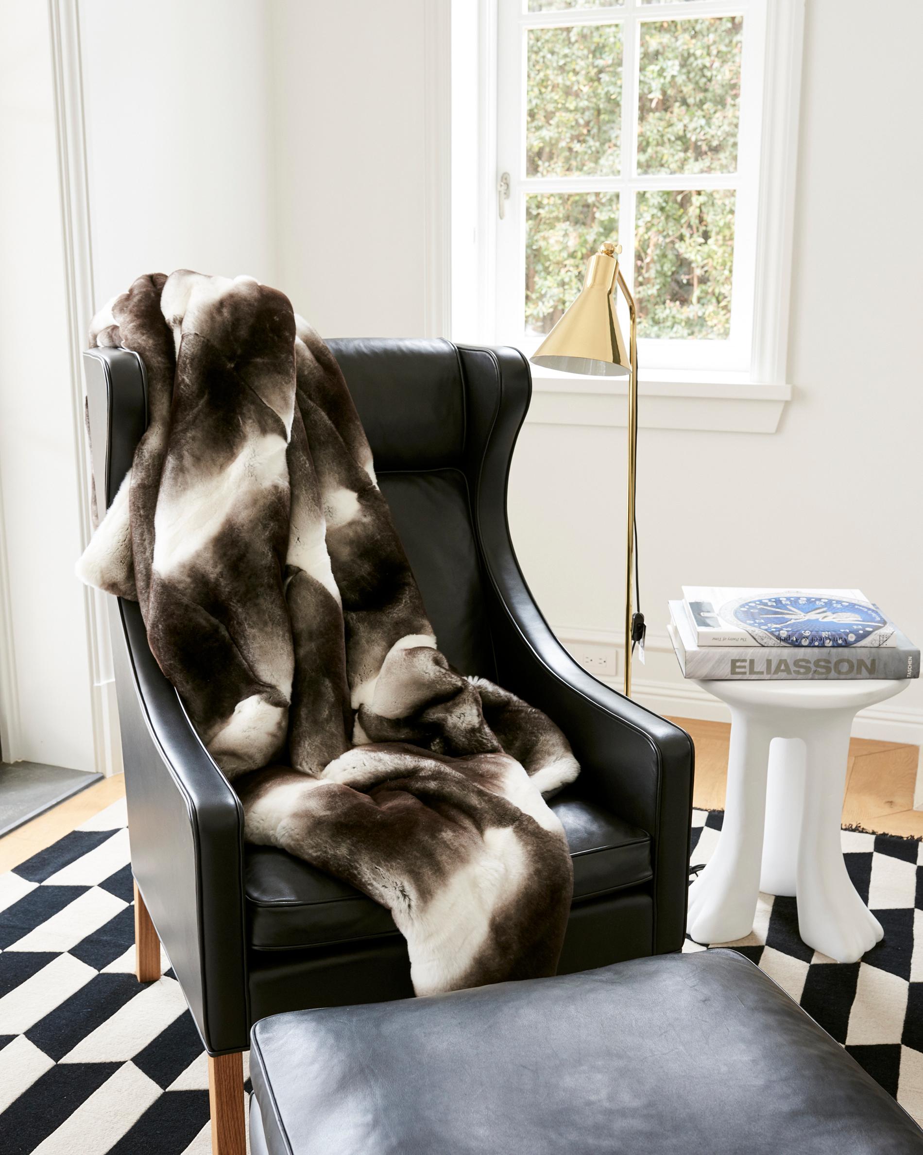 This exquisite throw is finished in pure Grey + White Orylag fur, which is produced solely in France and protected by a French trademark. This throw is backed in an elegant charcoal hue in 100% cashmere and is hand-crafted outside of Florence Italy.