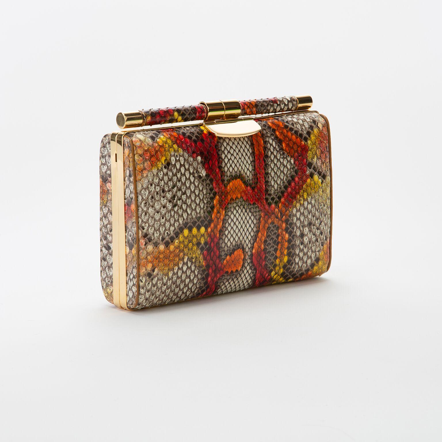 The Jamie Clutch is a structured square clutch with an optional cross-body chain and interior pocket. It features our slide-lock closure and signature Thayer blue satin lining. 

Size: Small
Hardware: Gold
Interior/Lining: Satin
Dimensions: 7.5” W x