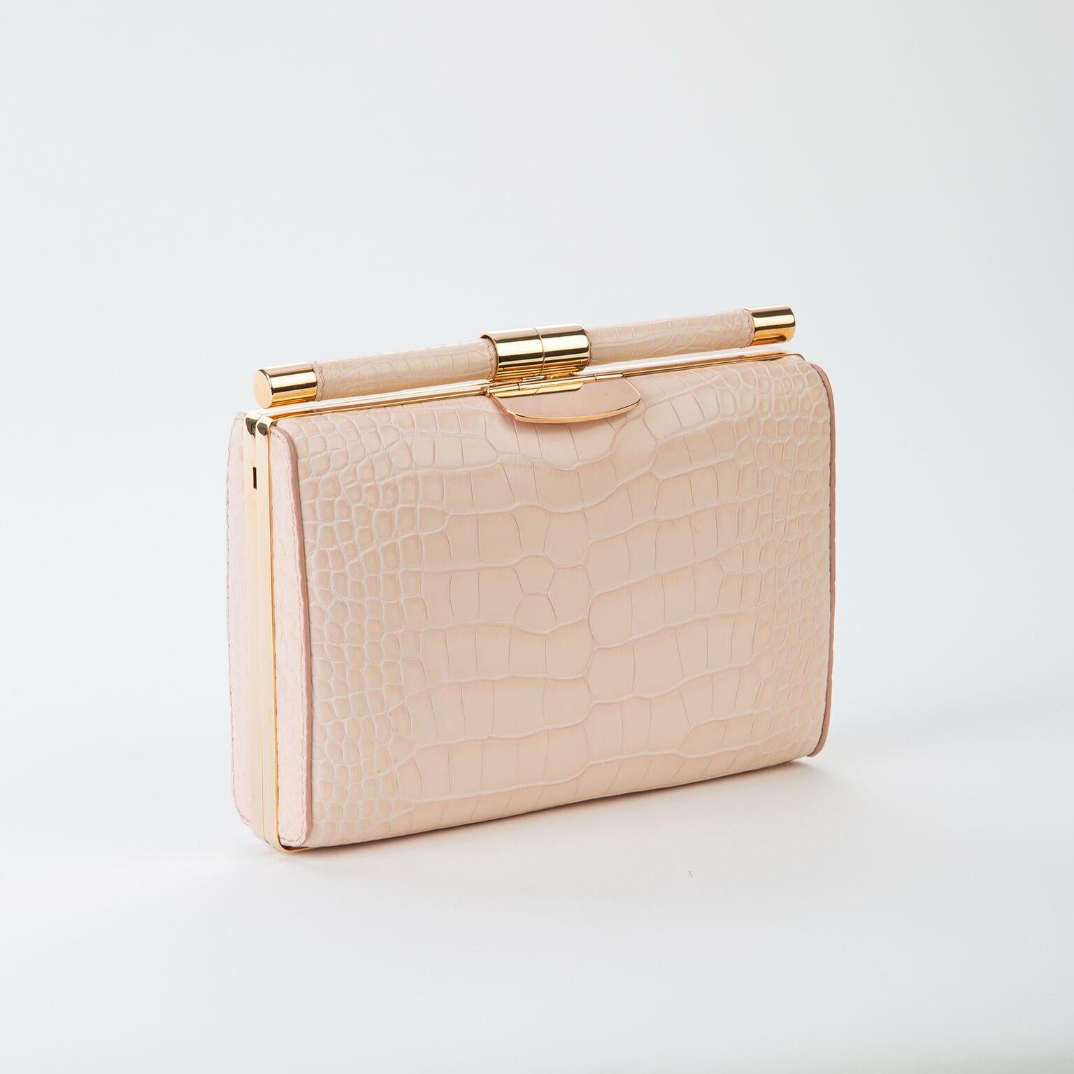 The Jamie Clutch is a structured square clutch with an optional cross-body chain and interior pocket. It features our slide-lock closure and signature Thayer blue satin lining. 

Size: Small
Hardware: Rose Gold
Interior/Lining: Satin
Dimensions: