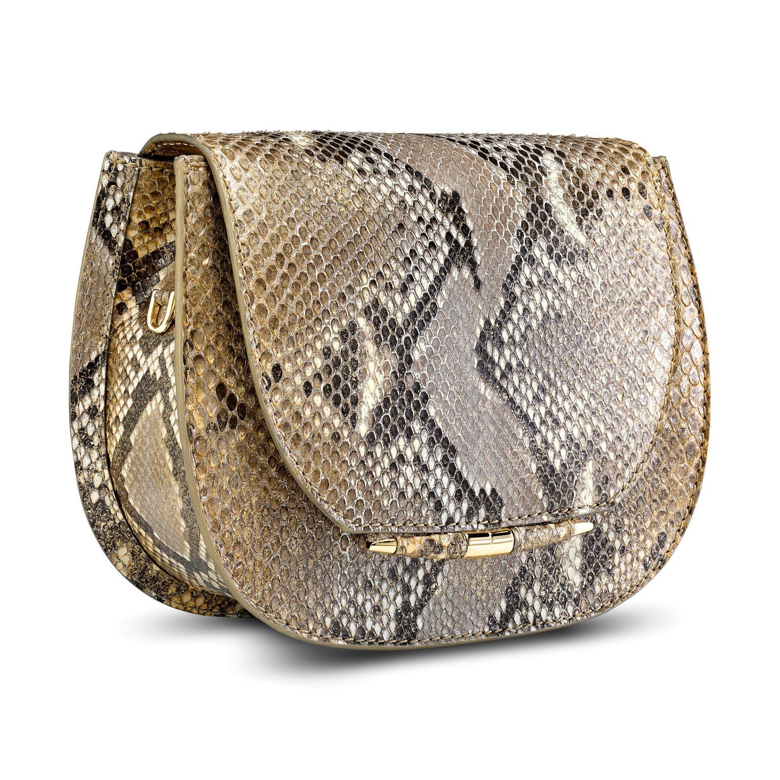 The Jane Saddle Small is featured in Metallic Gold Natural Python with gold hardware. The handbag is designed with a rounded three-quarter front flap, a magnetic snap closure and our custom Infinity Bar. It has a hidden exterior pocket, an optional