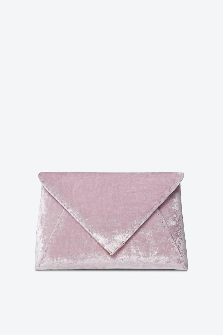 The Lee Pouchet Small is featured in our Pink Lemonade crushed velvet with gold hardware. The envelope-shaped clutch is designed with a triangular front flap and a magnetic snap closure. The Lee fits the large iPhone, has a hidden exterior pocket,
